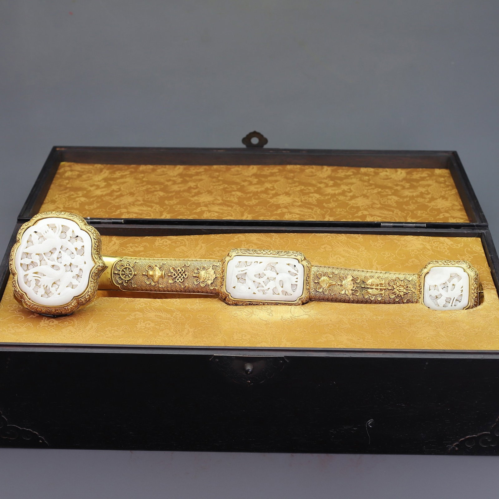 A Huge Gilt Bronze Inlaid White Jade Eight Treasures and Crane Pattern Ruyi: A Huge Gilt Bronze Inlaid White Jade Eight Treasures and Crane Pattern Ruyi,Qing Dynasty,China,Size:18.5inx3.9in,(Box)20.9inx9.1inx11.6in,Total Weight:5585g 铜鎏金镶白