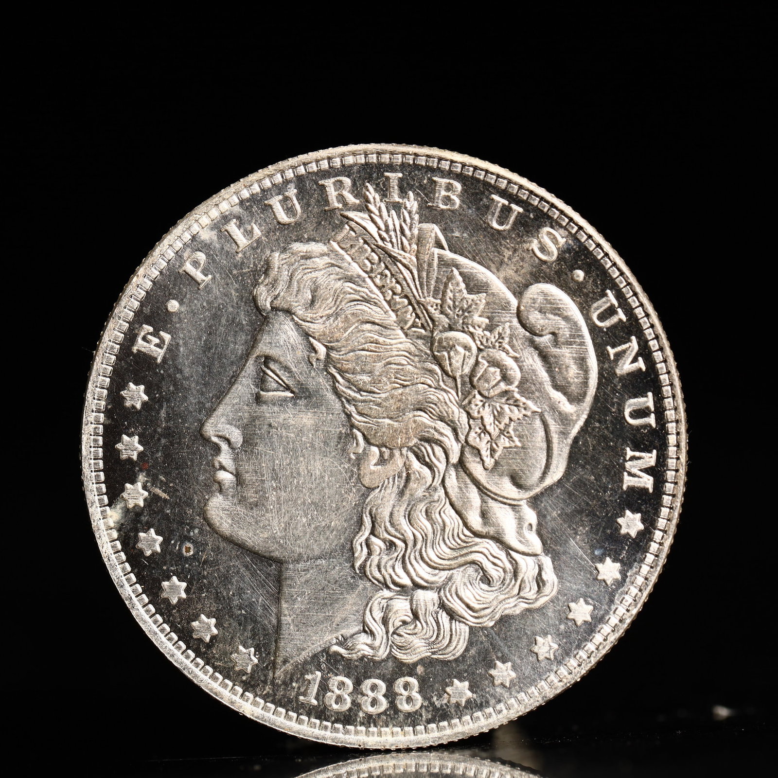 USA Morgan Dollar 1888 Coin: Obv: profile bust with date below and E PLURIBUS UNUM legend and stars around. Rev: eagle with In God we trust above within wreath with UNITED STATES OF AMERICA ONE DOLLAR legend. IN GOD WE TRUST /
