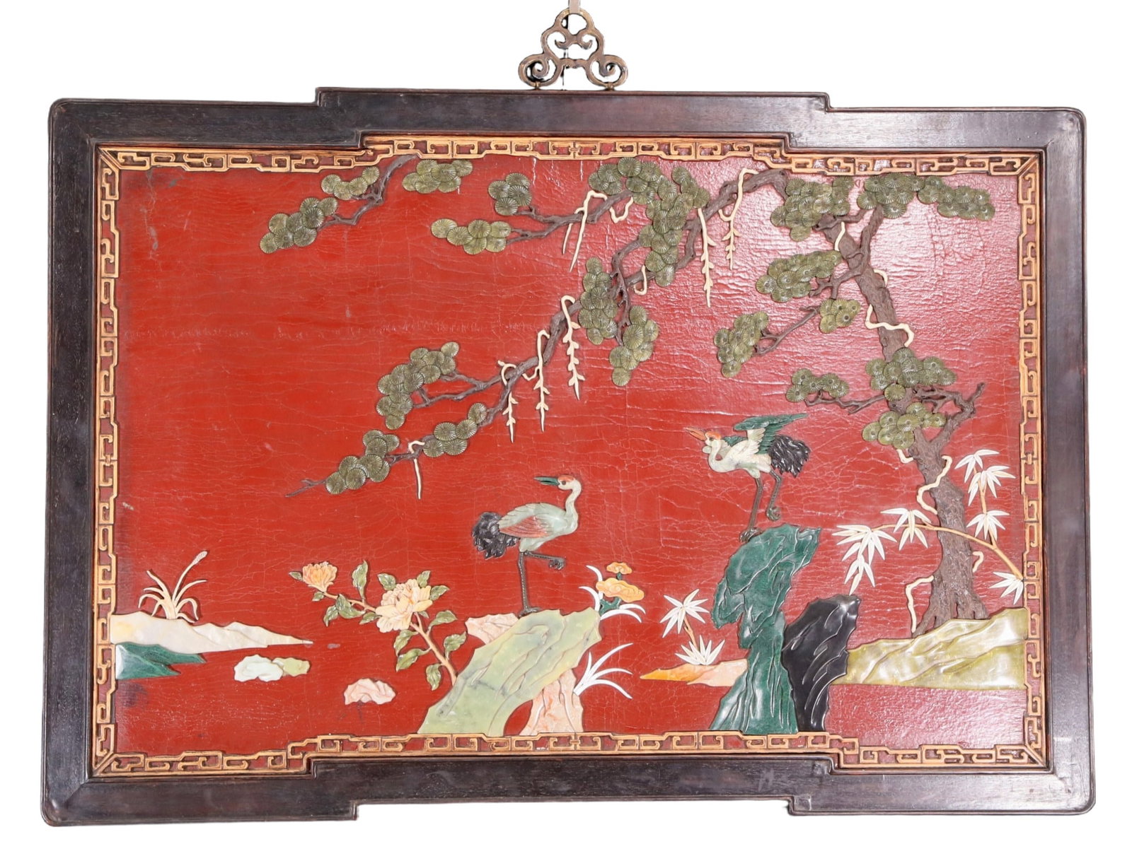 An exquisite zitanwood painted lacquered hanging screen with a pine and crane pattern inlaid with: An exquisite lacquered zitanwood hanging screen with a pine and crane pattern inlaid with gemstones. Qing Dynasty , China. using zitanwood as the base material and filled with lacquer using exquisite