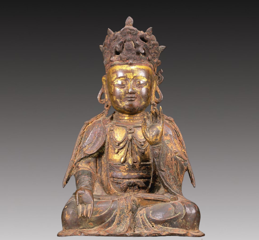 A Brilliant Gilt-Bronze Figure Of Guanyin: A Brilliant Gilt-Bronze Figure Of Guanyin. Seated with a serene expression,body rendered clad in long,flowing robes,the voluminous drapery elegantly cascading in folds. Chinese Ming Dynasty. Size:6.3i
