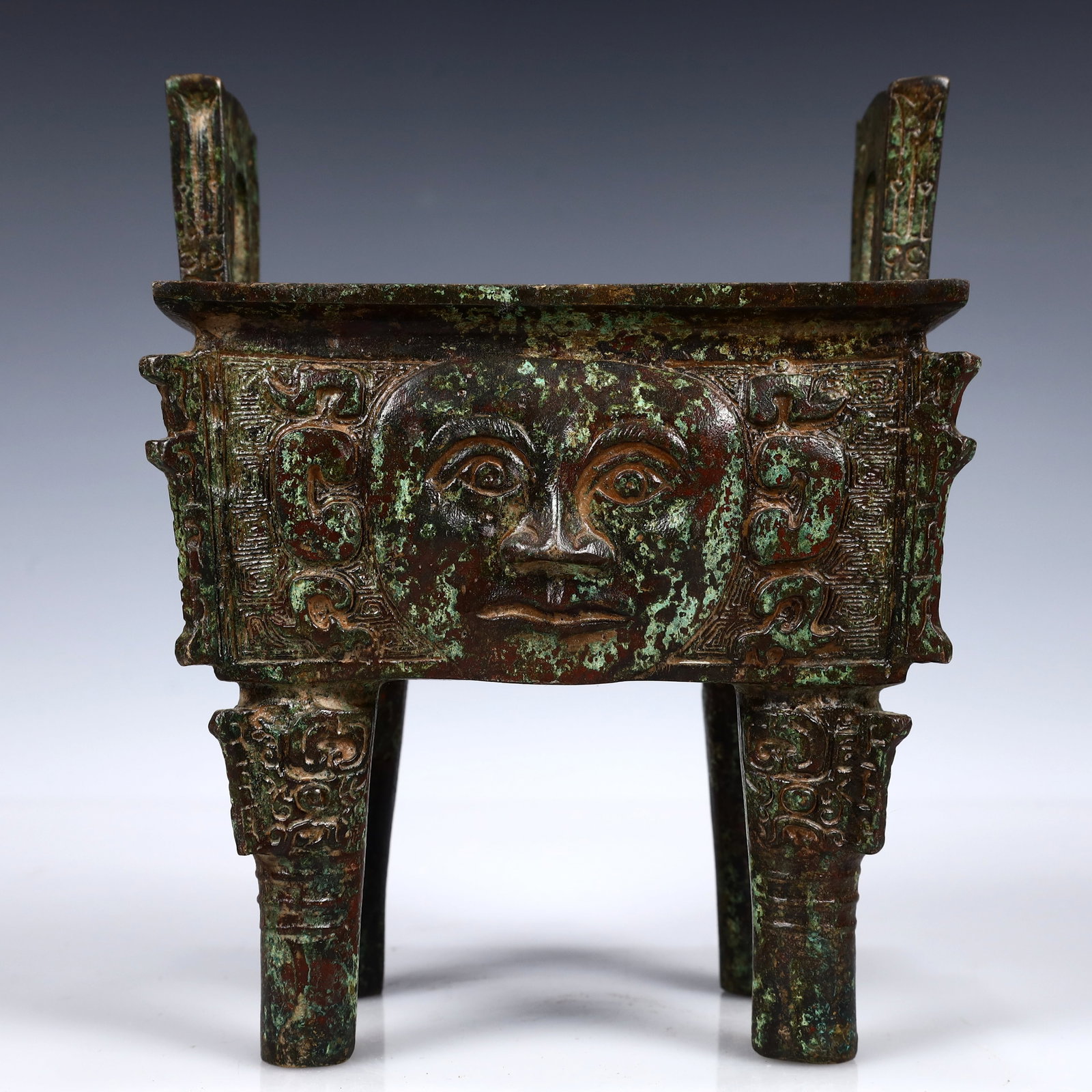 A Rare Bronze Human-Face Pattern Ding: A Rare Bronze Human-Face Pattern Ding,W.Zhou,China,Size:6.3inx4.7inx7.9in,Weight:1850g 青铜人面纹鼎,中国西周时期