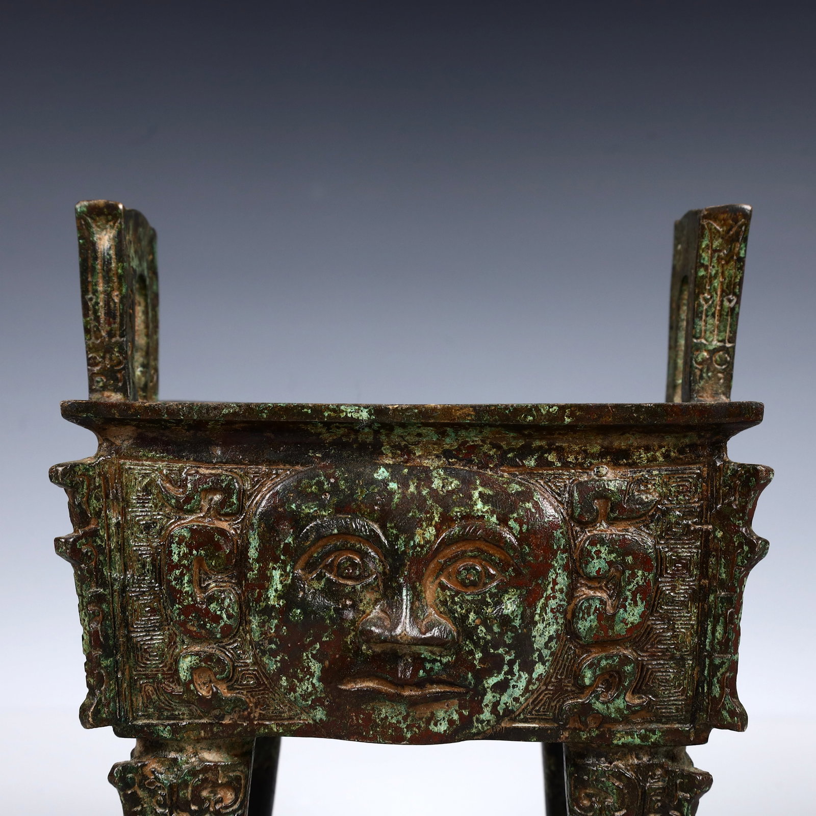 A Rare Bronze Human-Face Pattern Ding - 2