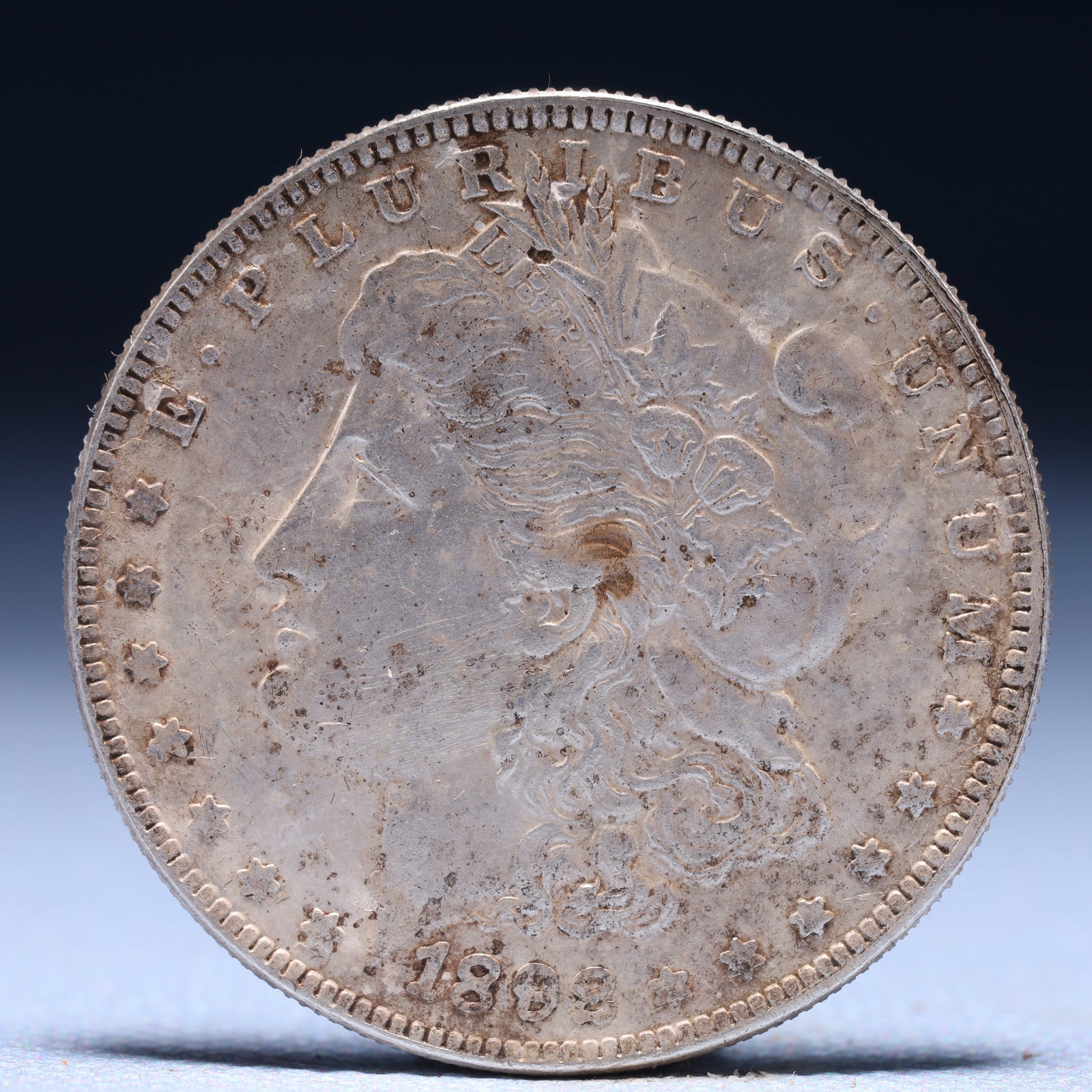 USA Morgan Dollar 1892 Coin: Obv: profile bust with date below and E PLURIBUS UNUM legend and stars around. Rev: eagle with In God we trust above within wreath with UNITED STATES OF AMERICA ONE DOLLAR legend. IN GOD WE TRUST / LI