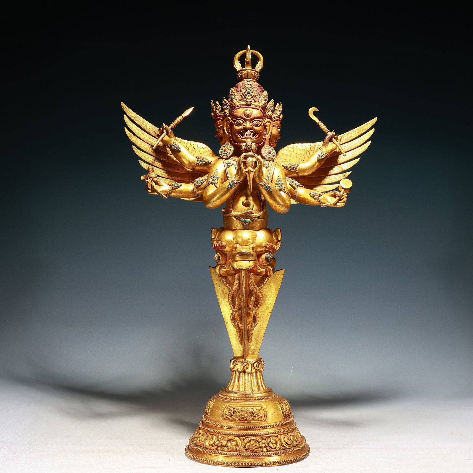 A Huge Gilt Bronze Statue of Garu?a Vajry Pestle,Inlaid Turquoise,With Base: A Huge Gilt Bronze Statue of Garuḍa Vajry Pestle,Inlaid Turquoise,With Base,Qing Dynasty, China,Size:18.9inx7.9inx29.9in,Weight:15000g 铜鎏金大鹏金翅