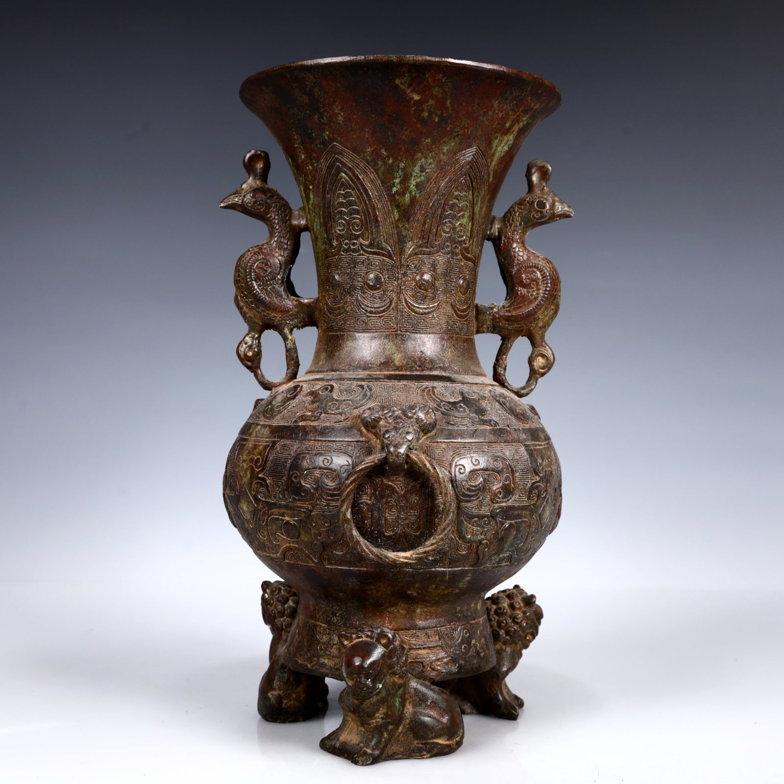 A Rare Bronze Auspicious Beast Pattern Phoenix-Ears and Tripod Vase: A Rare Bronze Auspicious Beast Pattern Phoenix-Ears and Tripod Vase,W.Zhou,China,Size:6.3inx11in,Weight:2350g 青铜瑞兽纹凤耳三足瓶,中&