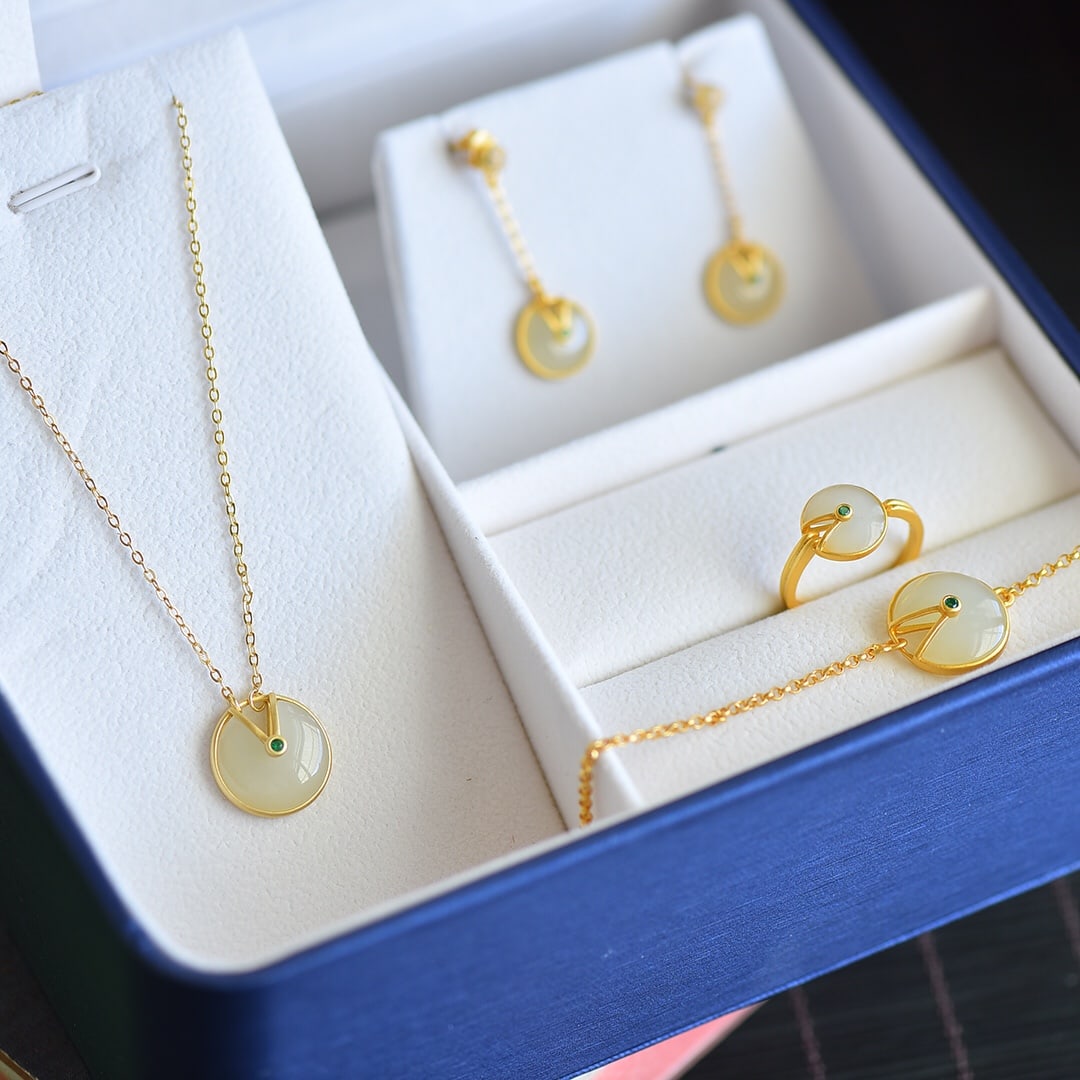 A Pair of Exquisite Sterling Silver-Gold Plated Inlaid White Jade Jewely: A Pair of Exquisite Sterling Silver-Gold Plated Inlaid White Jade Jewelry,Size:(Necklace)14mmx14mm,(Ring)10mmx10mm,(Earrings)10mmx10mm 一套纯银镀金镶白&