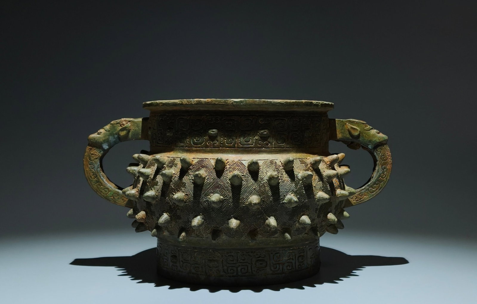 An Archaic Bronze Beast-Ears Food Vessel: An Archaic Bronze Beast-Ears Food Vessel,W.Zhou,China,Size:7.7inx13.4inx8.7in 青铜兽耳食器,中国西周时期