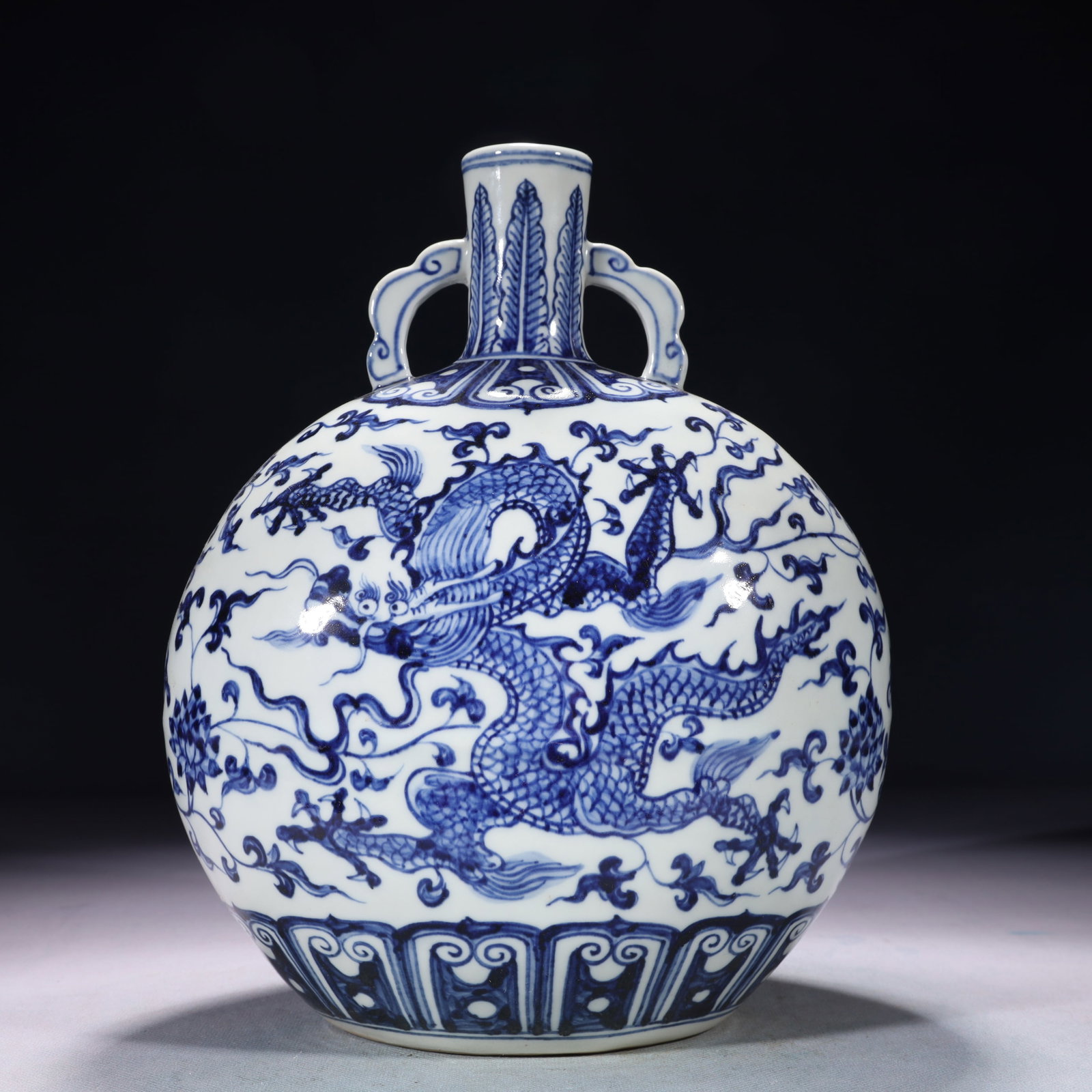 An Exquisite Blue and White Lotus and Dragon Pattern Double-Ears Vase: An Exquisite Blue and White Lotus and Dragon Pattern Double-Ears Vase,Ming Dynasty,China,Xuande Six-character Mark,Size:8.3inx5.1inx11in,Weight:1800g
