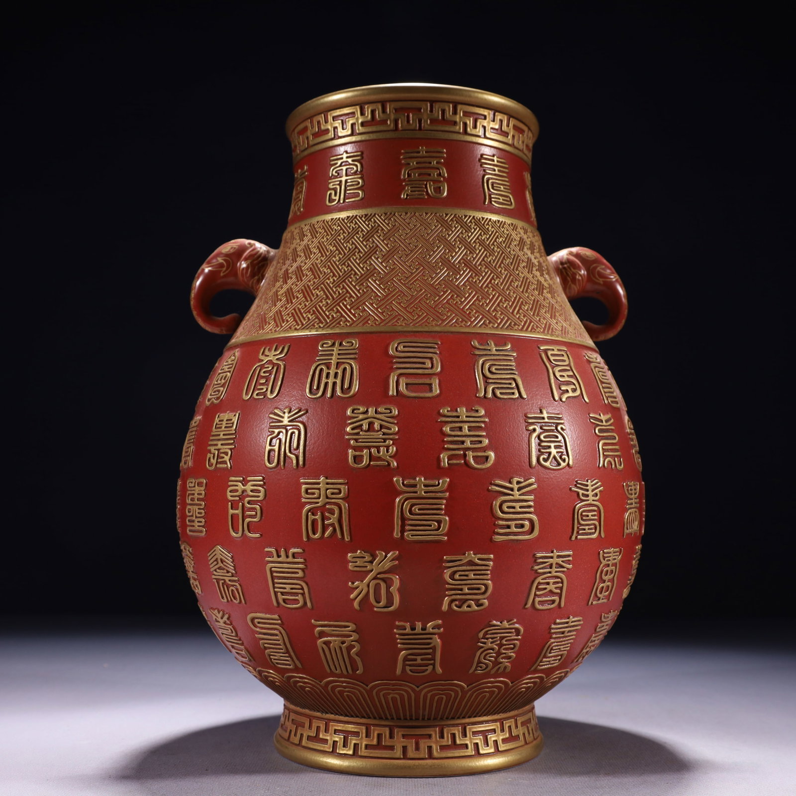 An Exquisite Red Glazed Painted Gold Shou-Character Pattern Double-Ears Vase: An Exquisite Red Glazed Painted Gold Shou-Character Pattern Double-Ears Vase,Qing Dynasty,China,Qianlong Six-character Mark,Size:8.3inx11.8in,Weight:2250g 红釉描金寿é