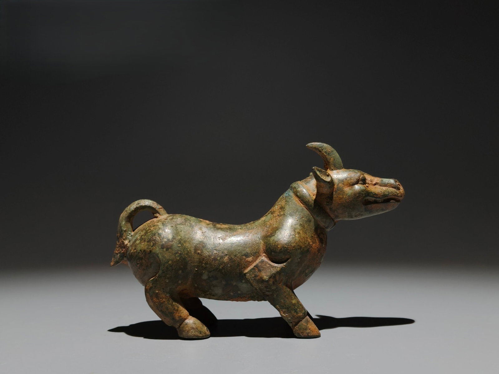 An Archaic Bronze Unicorn Ornament: An Archaic Bronze Unicorn Ornament,the Warring States period in China,Size:4.3inx6.5inx2.2in 青铜独角兽摆件,中国战国时期
