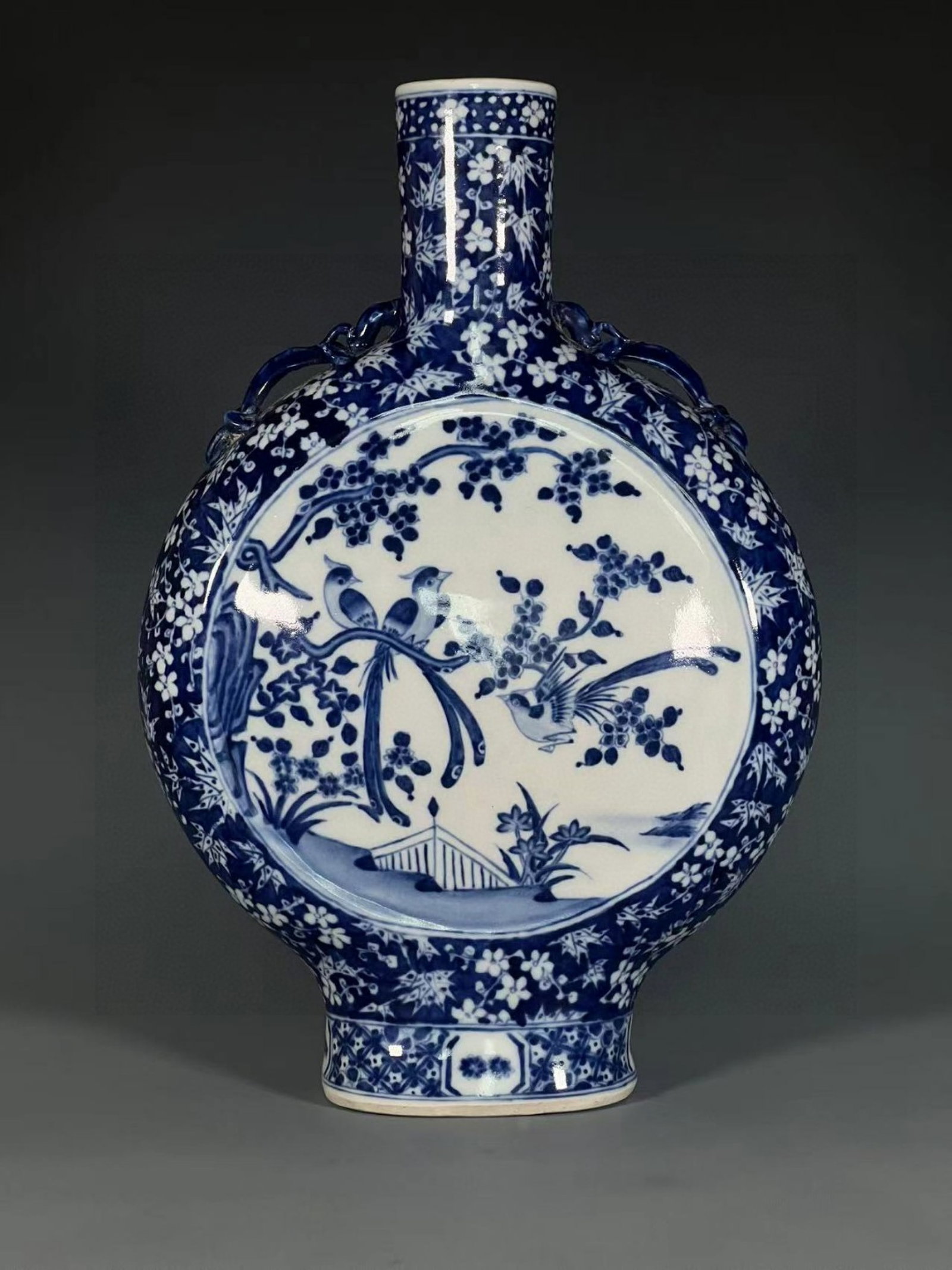 A Rare Blue and White Flower and Bird Pattern Double-Ears Vase: A Rare Blue and White Flower and Bird Pattern Double-Ears Vase,Qing Dynasty,China,Qianlong Six-character Mark,Size:15.1inx4.7in 青花花鸟纹双耳瓶,中