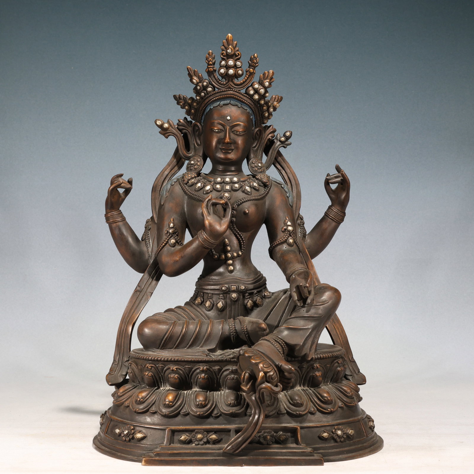 A Solemn Bronze Inlaid Silver Four-arms Buddha Statue: A Solemn Bronze Inlaid Silver Four-arms Buddha Statue,Qing Dynasty, China,Size:19.3inx12.6inx8.7in 铜嵌银四臂佛像,中国清代