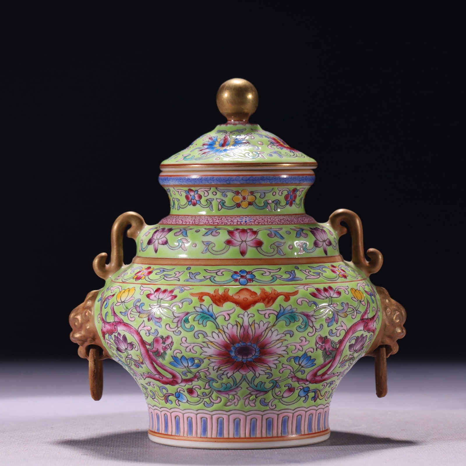 An Exquisite Green Ground Enamel Lotus and Dragon Pattern Double-Ears Jar with Cover: An Exquisite Green Ground Enamel Lotus and Dragon Pattern Double-Ears Jar with Cover,Qing Dynasty,China,Qianlong Six-character Mark,Size:5.5inx5.9in,Weight:541g 绿地珐琅彩