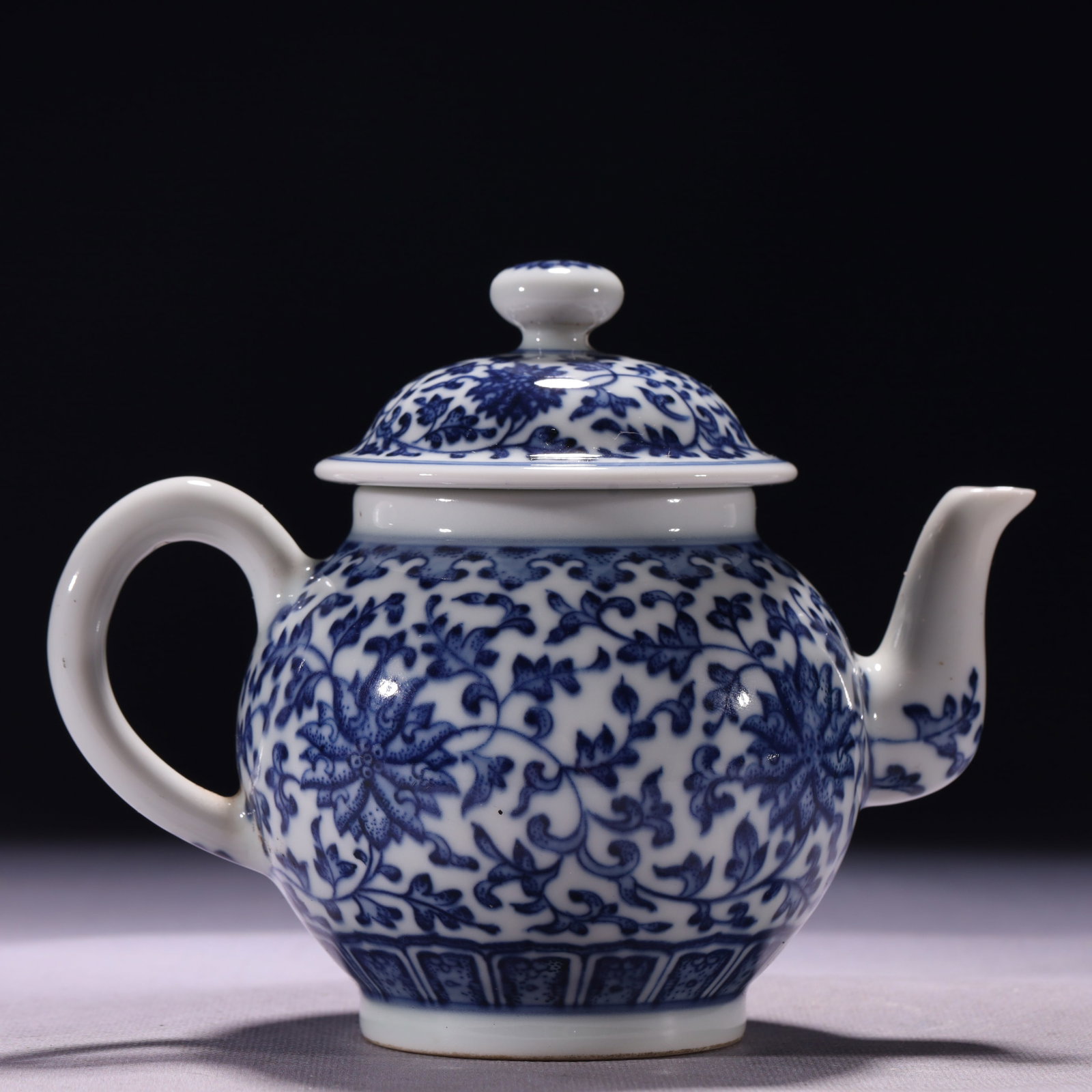 An Exquisite Blue and White Lotus Pattern Teapot: An Exquisite Blue and White Lotus Pattern Teapot,Qing Dynasty,China,Yongzheng Six-character Mark,Size:6.5inx3.9inx5.1in,Weight:525g 青花缠枝莲纹茶壶,
