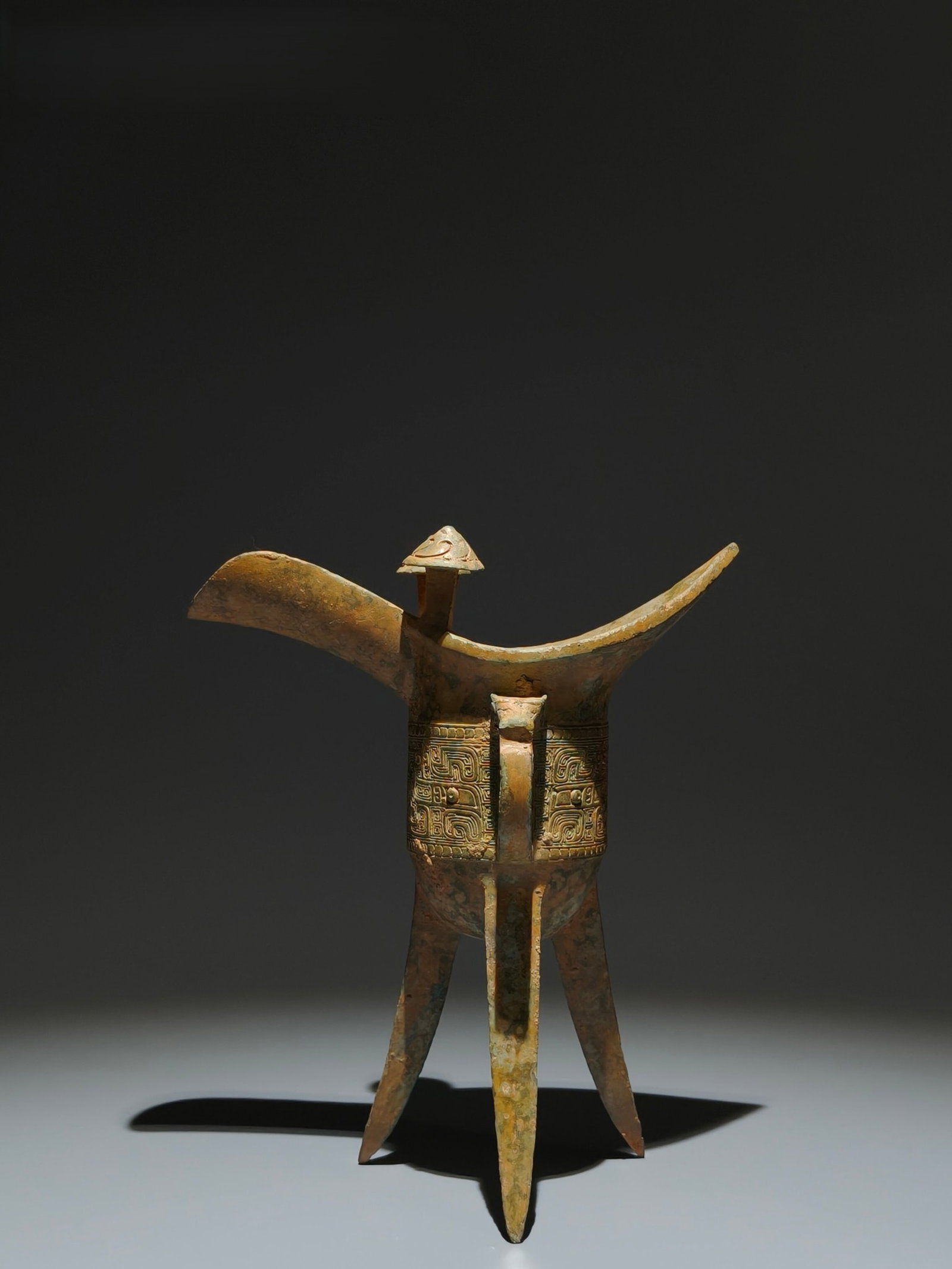 An Archaic Bronze Beast-Face Pattern Tripod Cup: An Archaic Bronze Beast-Face Pattern Tripod Cup,Shang Dynasty,China,Size:8.5inx7.1inx3.9in 青铜兽面纹三足杯子,中国商代