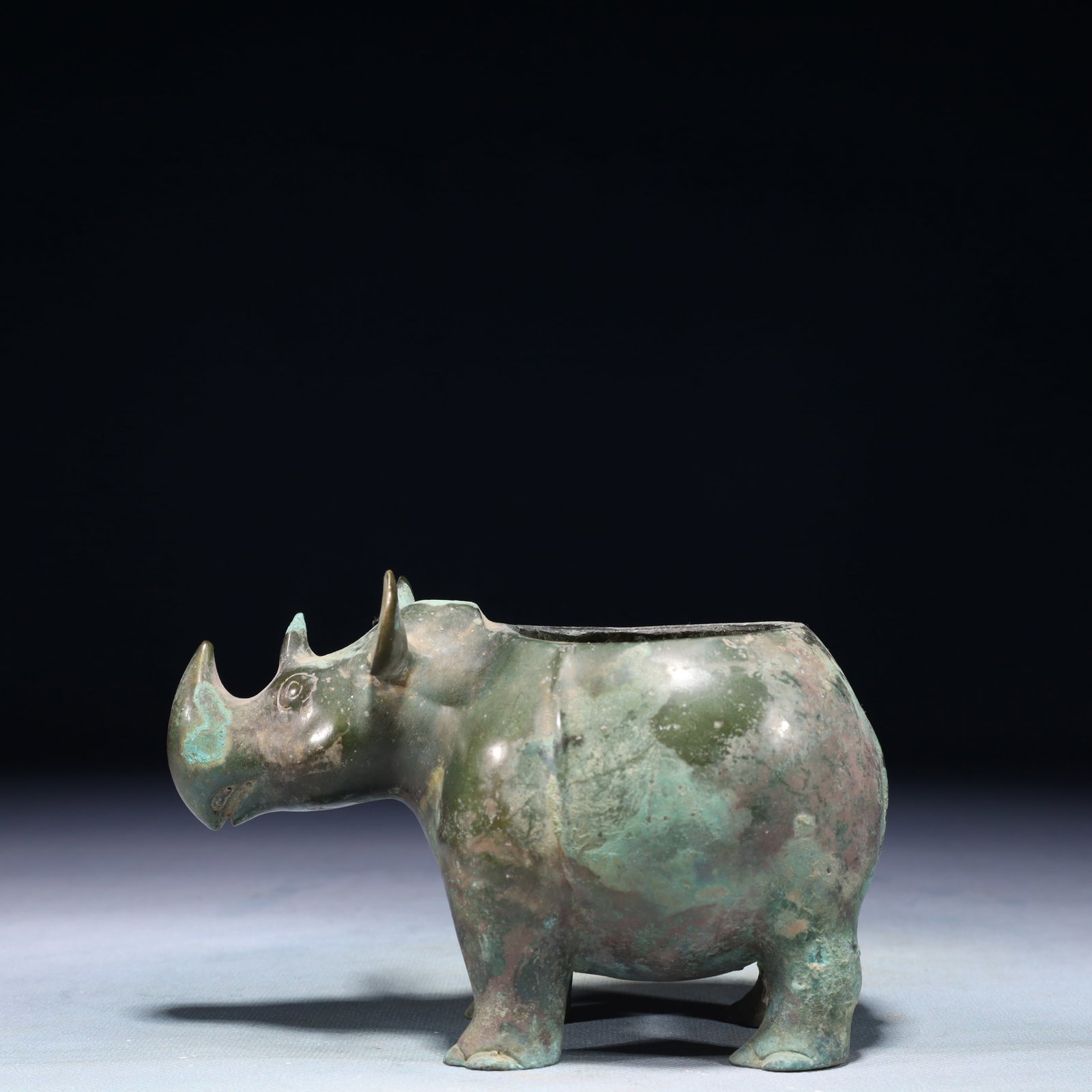 A Rare Bronze Rhinoceros Wine vessel: A Rare Bronze Rhinoceros Wine vessel,Western Zhou Dynasty,China,Size:5.9inx3.1inx3.9in,Weight:750g 青铜犀牛酒器,中国西周时期