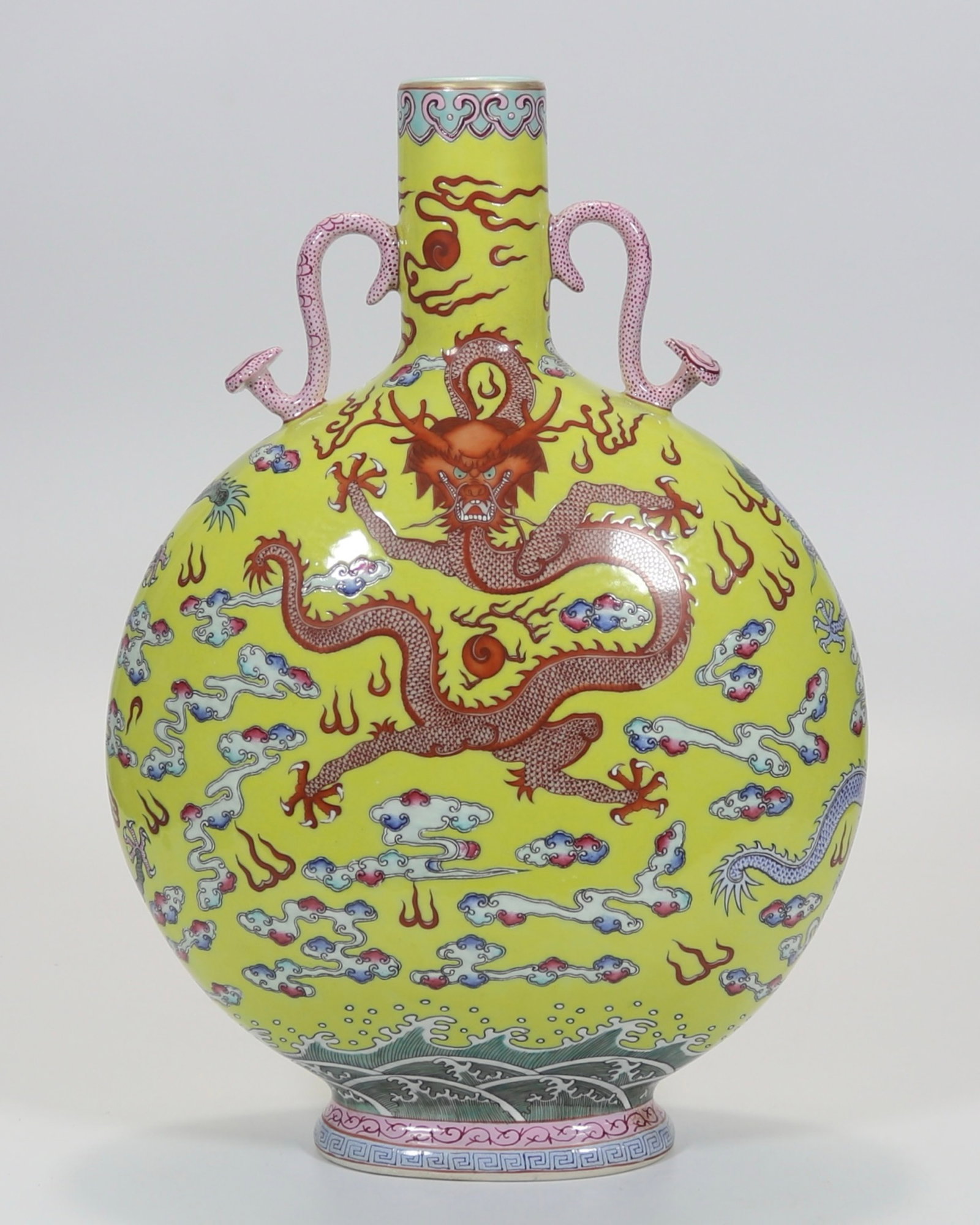 A fine yellow-ground famille rose sea-wave dragon moonflask with ruyi handles: A fine yellow-ground famille rose sea-wave dragon moonflask with ruyi handles, Qing Dynasty, China, with six-character Qianlong reign mark, Size:13.7inx9.4in 黄地粉彩海&#