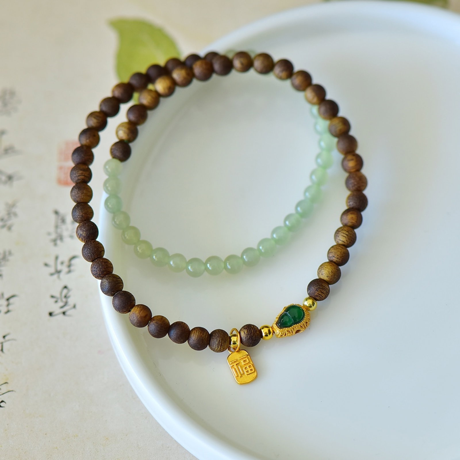An Exquisite Sterling Silver-Gold Plated Inlaid White Jade Bracelets,With Greenish Jade with: An Exquisite Sterling Silver-Gold Plated Inlaid White Jade Bracelets,With Greenish Jade with Eaglewood,Size:4mmx4mm 纯银镀金镶白玉手串,配