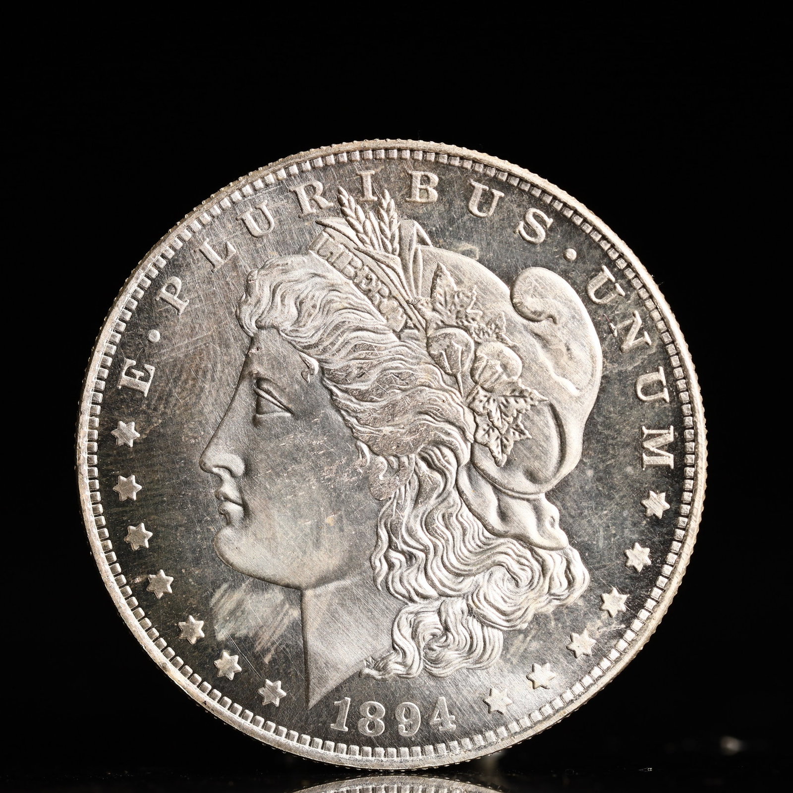 USA Morgan Dollar 1894 Coin: Obv: profile bust with date below and E PLURIBUS UNUM legend and stars around. Rev: eagle with In God we trust above within wreath with UNITED STATES OF AMERICA ONE DOLLAR legend. IN GOD WE TRUST / LI