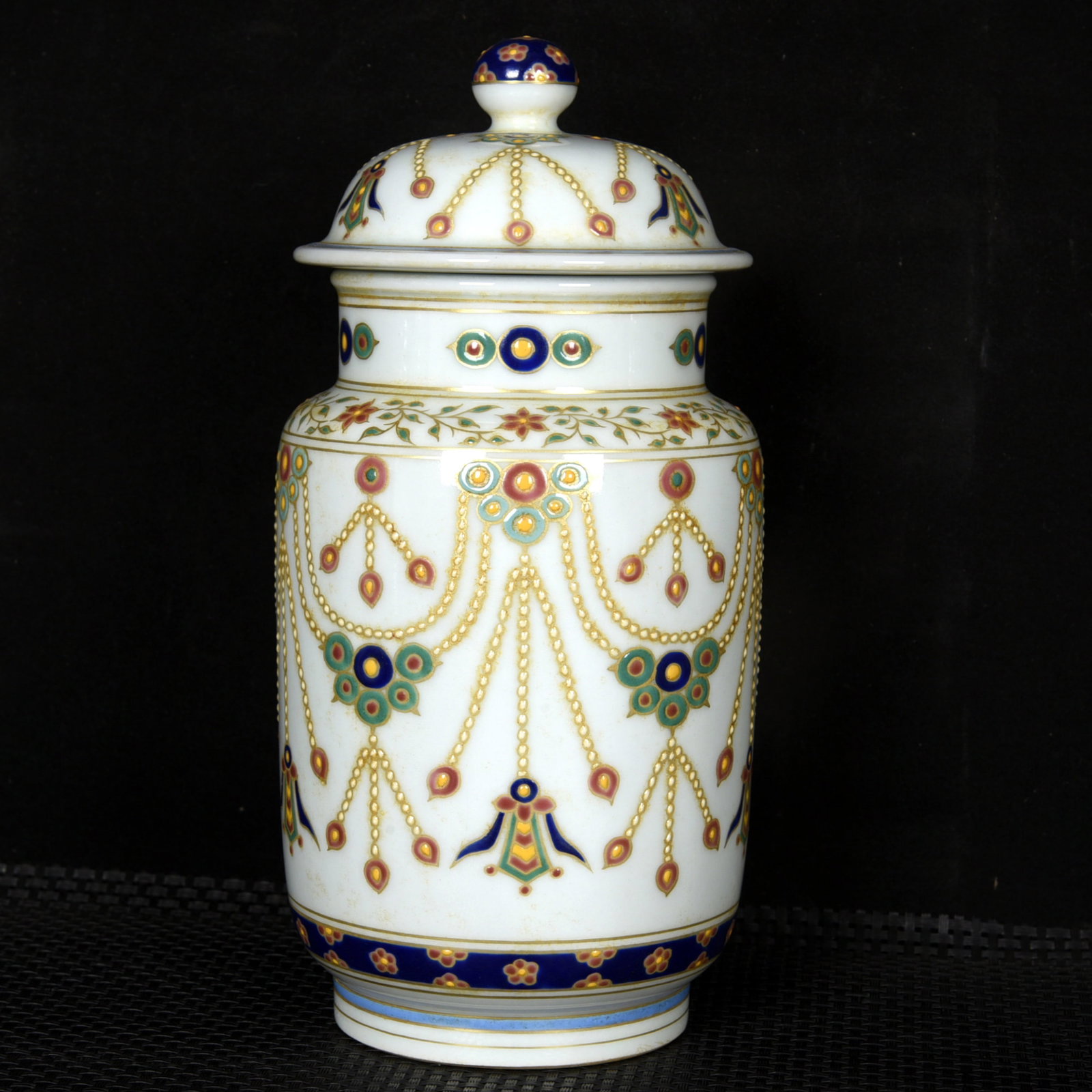 An Exquisite Wucai Painted Gold Flower Pattern Jar with Cover: An Exquisite Wucai Painted Gold Flower Pattern Jar with Cover,Ming Dynasty,China,Xuande Six-character Mark,Size:9.4inx4.3in 五彩描金花卉纹盖罐,
