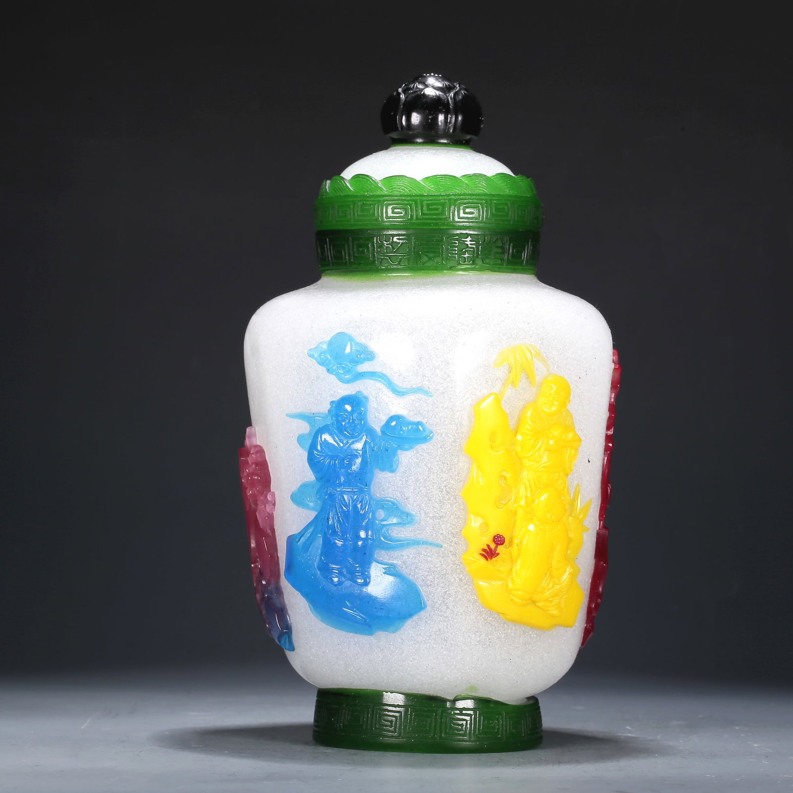 A Multi-Color Overlay White Glass 'Figure' Jar And Cover: A Multi-Color Overlay White Glass 'Figure' Jar And Cover. The top is painted in green with a key-fret border. Chinese Qing Dynasty. Qianlong Four-Character Mark. Size:4.5inx8.5in 清代 