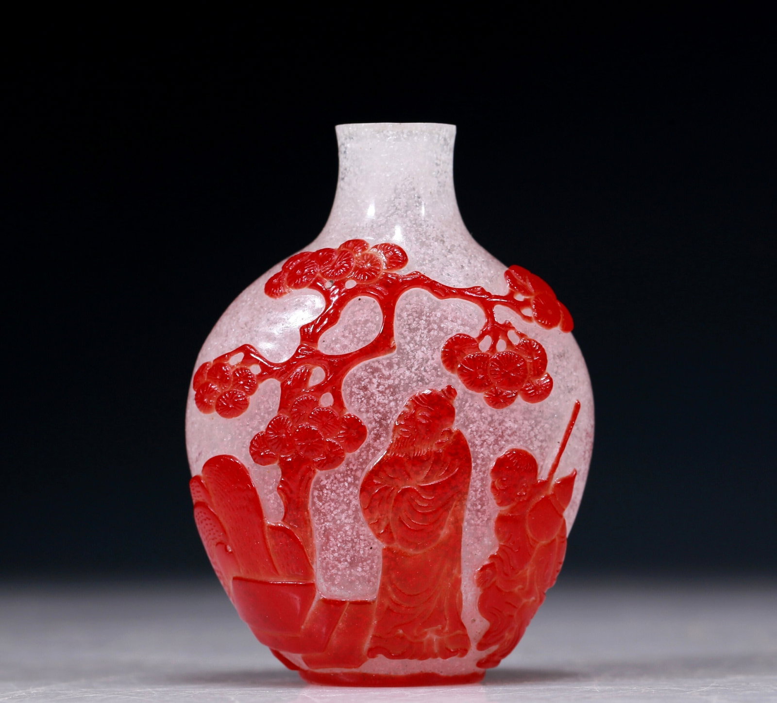 An Excellent Red Overlay Snowflake Glass 'Figure' Snuff Bottle: An Excellent Red Overlay Snowflake Glass 'Figure' Snuff Bottle. Each's body is rendered clad in long, flowing robes, the voluminous drapery elegantly cascading in folds, also carved with a lush pine