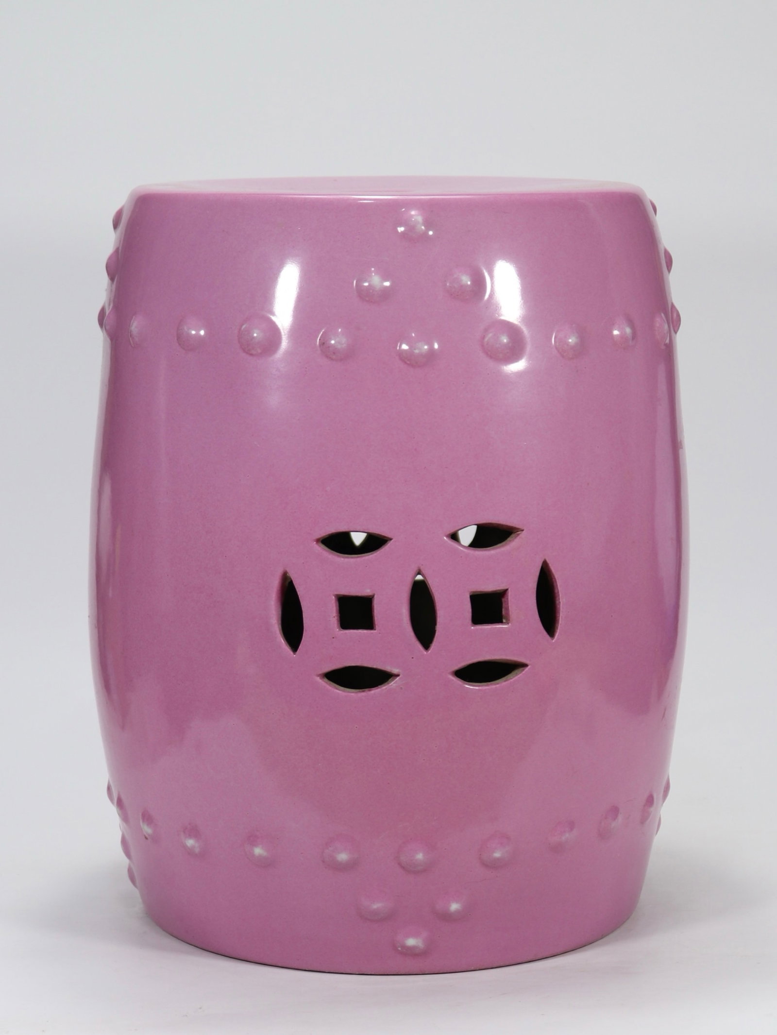 A fine rouge-pink glazed drum-shaped garden seat with openwork coin pattern and studs: A fine rouge-pink glazed drum-shaped garden seat with openwork coin pattern and studs, Qing Dynasty, China, Size:15.7inx10.6in