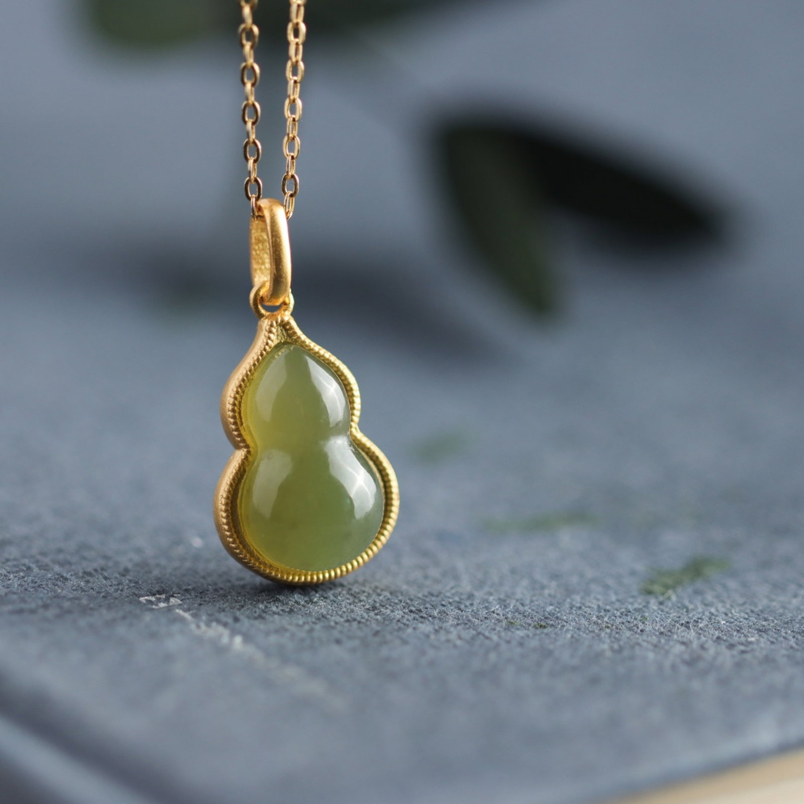 An Exquisite Sterling Silver-Gold Plated Inlaid Sapphire Gourd Pendant: An Exquisite Sterling Silver-Gold Plated Inlaid Sapphire Gourd Pendant 纯银镀金镶青玉葫芦吊坠