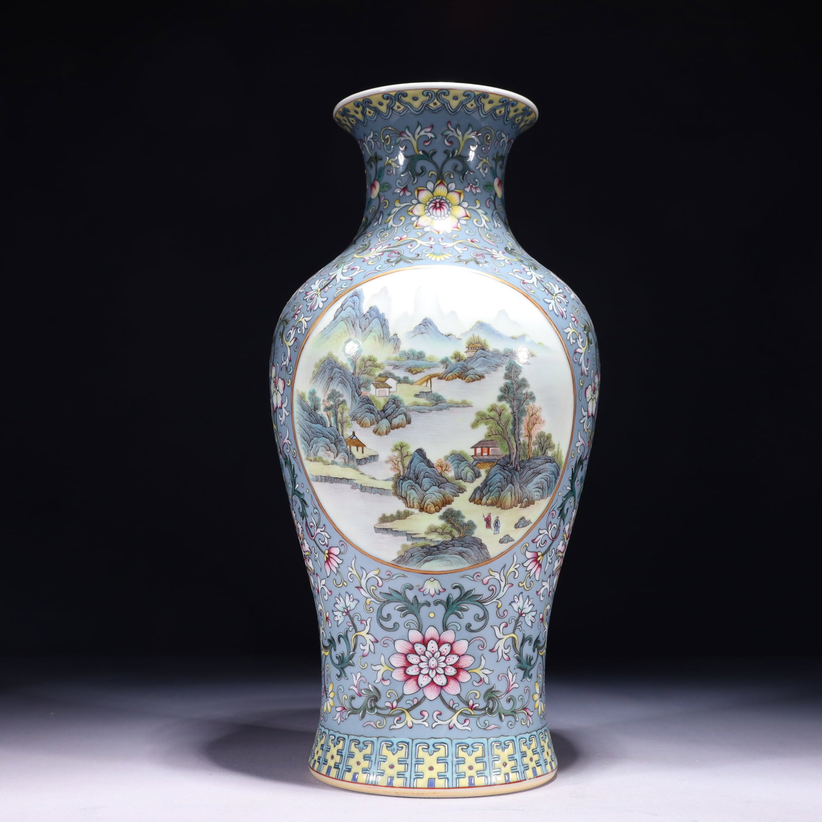 An Exquisite Blue Ground Famille-Rose Landscape Pattern Vase: An Exquisite Blue Ground Famille-Rose Landscape Pattern Vase,Qing Dynasty,China,Qianlong Six-character Mark,Size:6.3inx15in,Weight:2850g 蓝地粉彩山水纹瓶