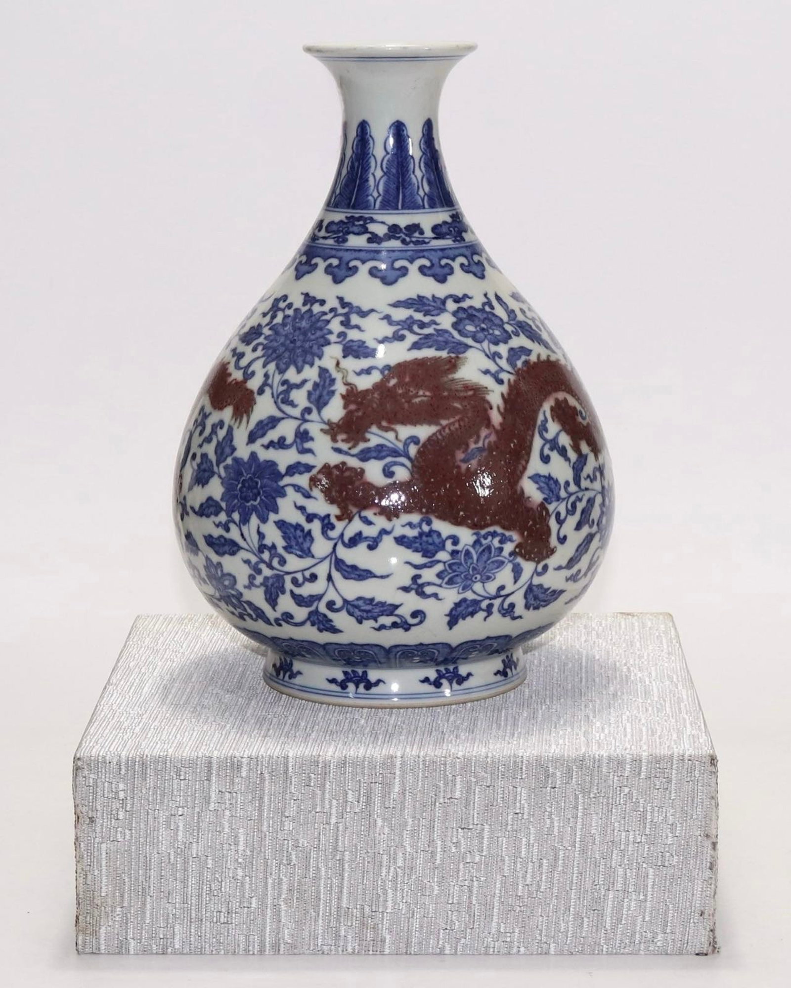 An Exquisite Blue and White Underglaze-Red Lotus and Dragon Pattern Vase: An Exquisite Blue and White Underglaze-Red Lotus and Dragon Pattern Vase,Qing Dynasty,China,Qianlong Six-character Mark,Size:10.6inx2.9in