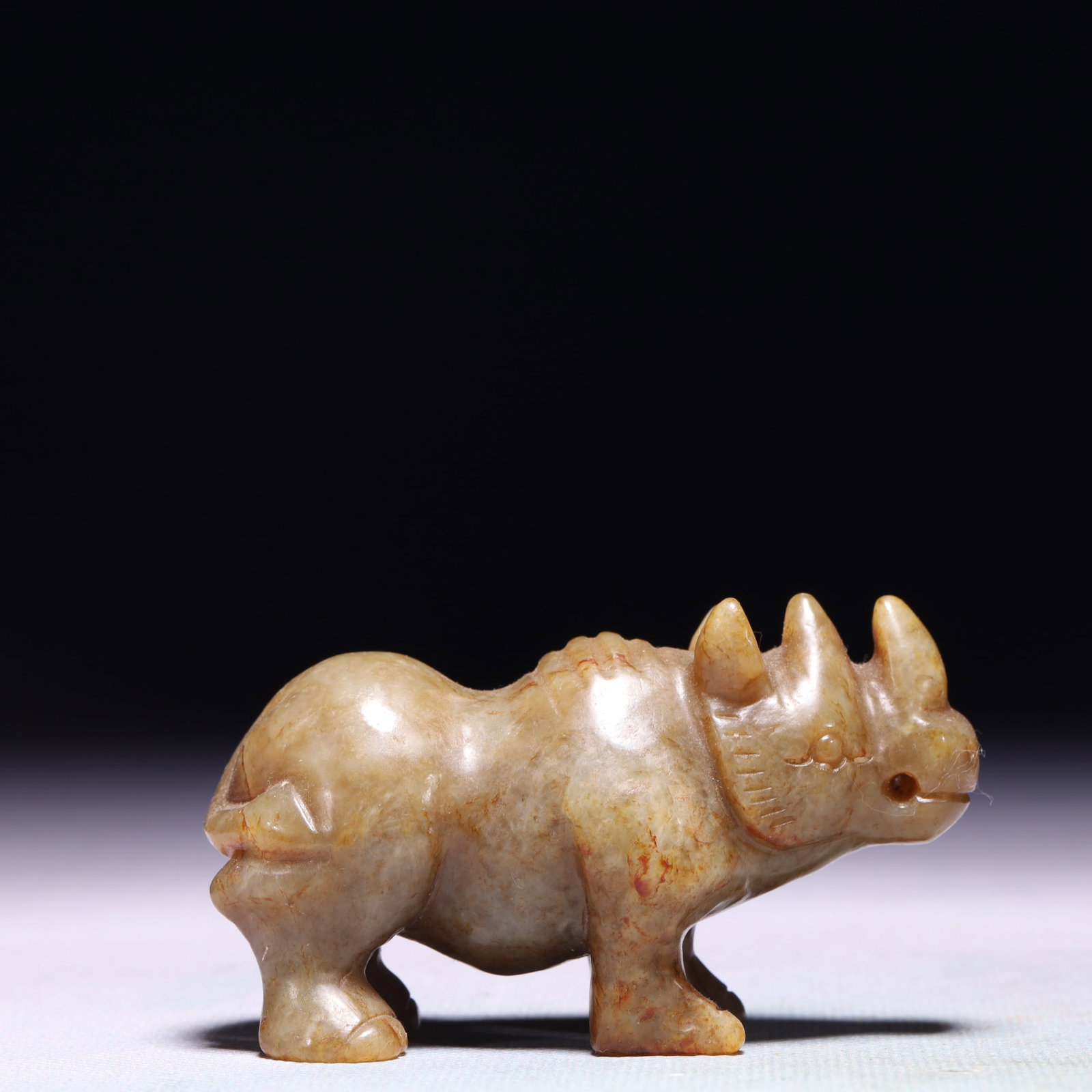 An Exquisite Archaic Jade Rhinoceros Ornament: An Exquisite Archaic Jade Rhinoceros Ornament,Ancient Time,China,Size:3.1inx1.2inx1.6in,Weight:150.5g 高古玉犀牛摆件,中国远古时&