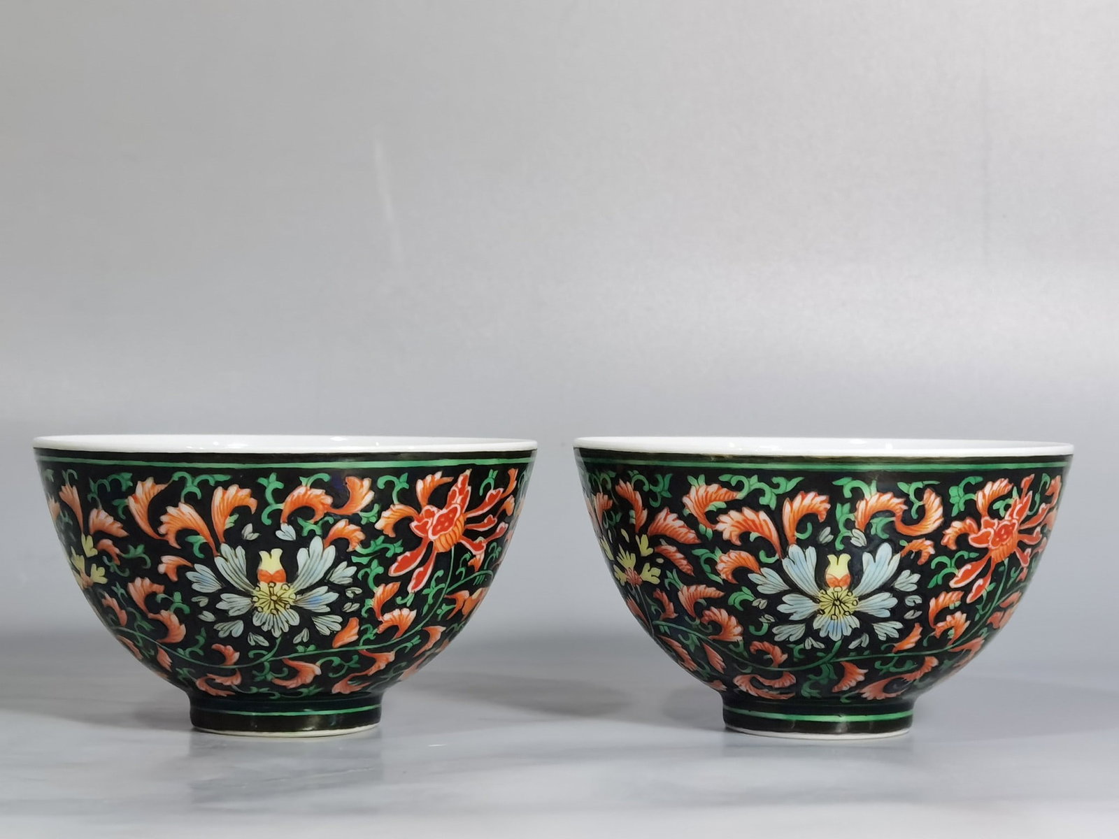 A Pair of Exquisite Black Ground Famille-Rose Lotus Pattern Cups (1 of 8)