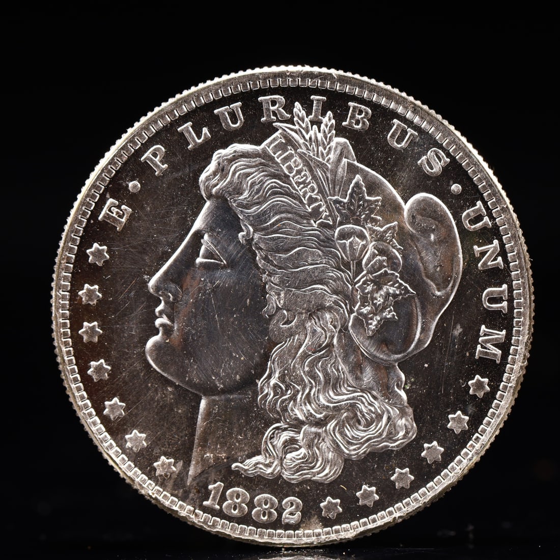 USA Morgan Dollar 1882 Coin: Obv: profile bust with date below and E PLURIBUS UNUM legend and stars around. Rev: eagle with In God we trust above within wreath with UNITED STATES OF AMERICA ONE DOLLAR legend. IN GOD WE TRUST /