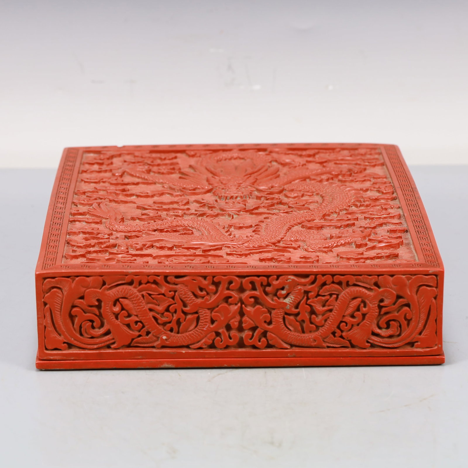 A Craved Red Lacquer Auspicious Cloud and Dragon Pattern Box: A Craved Red Lacquer Auspicious Cloud and Dragon Pattern Box,Qing Dynasty,China,Siize:12.4inx9.8inx3in 剔红漆祥云龙纹盒,中国清代