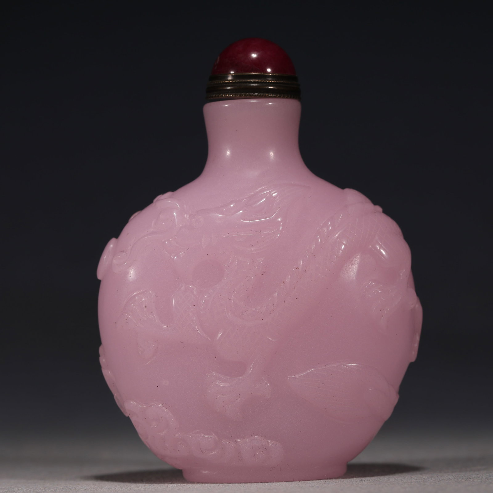 An Exquisite Pink Glass Relief Cloud Dragon Playing Pearl Pattern Snuff Bottle: An Exquisite Pink Glass Relief Cloud Dragon Playing Pearl Pattern Snuff Bottle,Qing Dynasty, China,Qianlong Four-character Mark,Size:2.4in×1in×3.1in