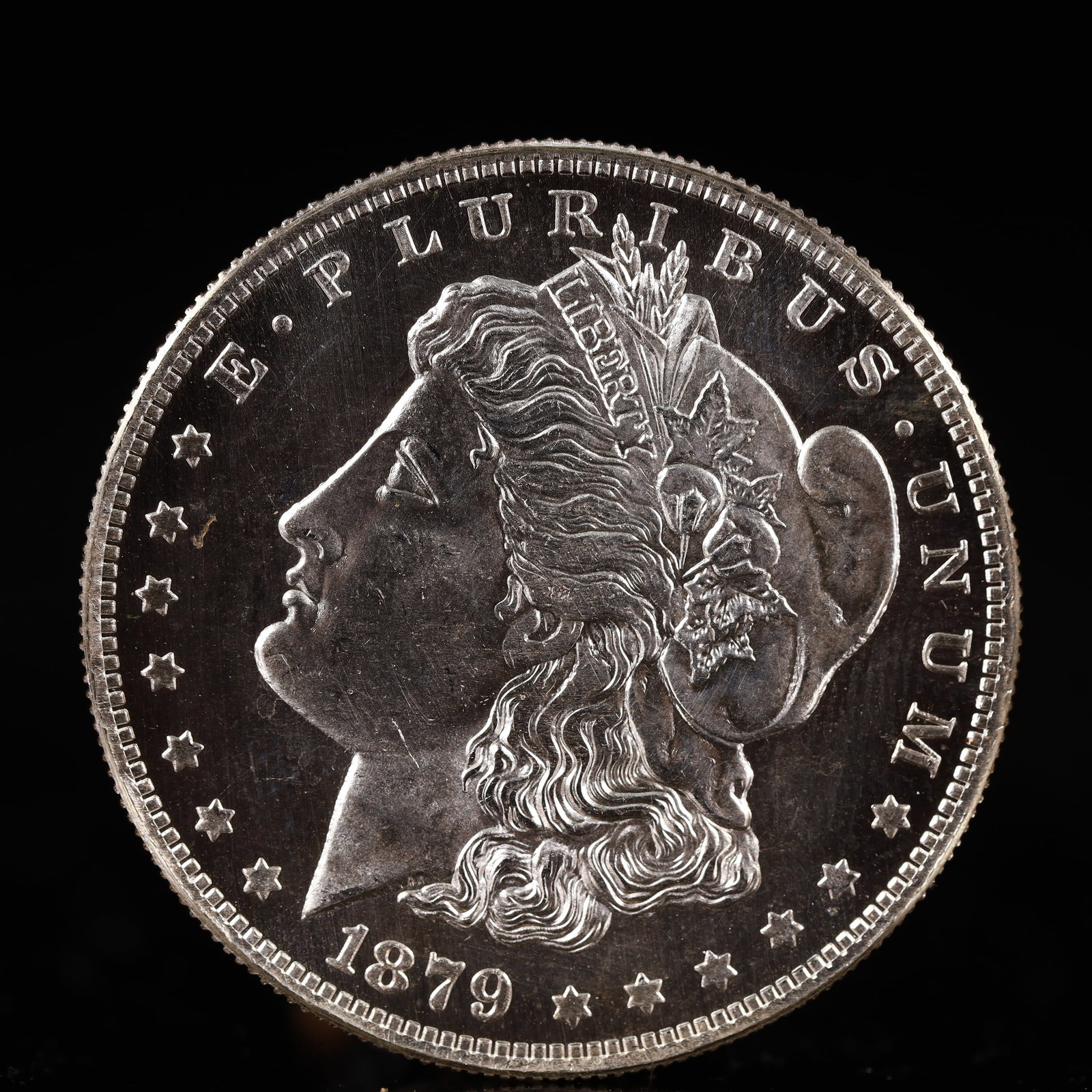 USA Morgan Dollar 1879 Coin: Obv: profile bust with date below and E PLURIBUS UNUM legend and stars around. Rev: eagle with In God we trust above within wreath with UNITED STATES OF AMERICA ONE DOLLAR legend. IN GOD WE TRUST / LI