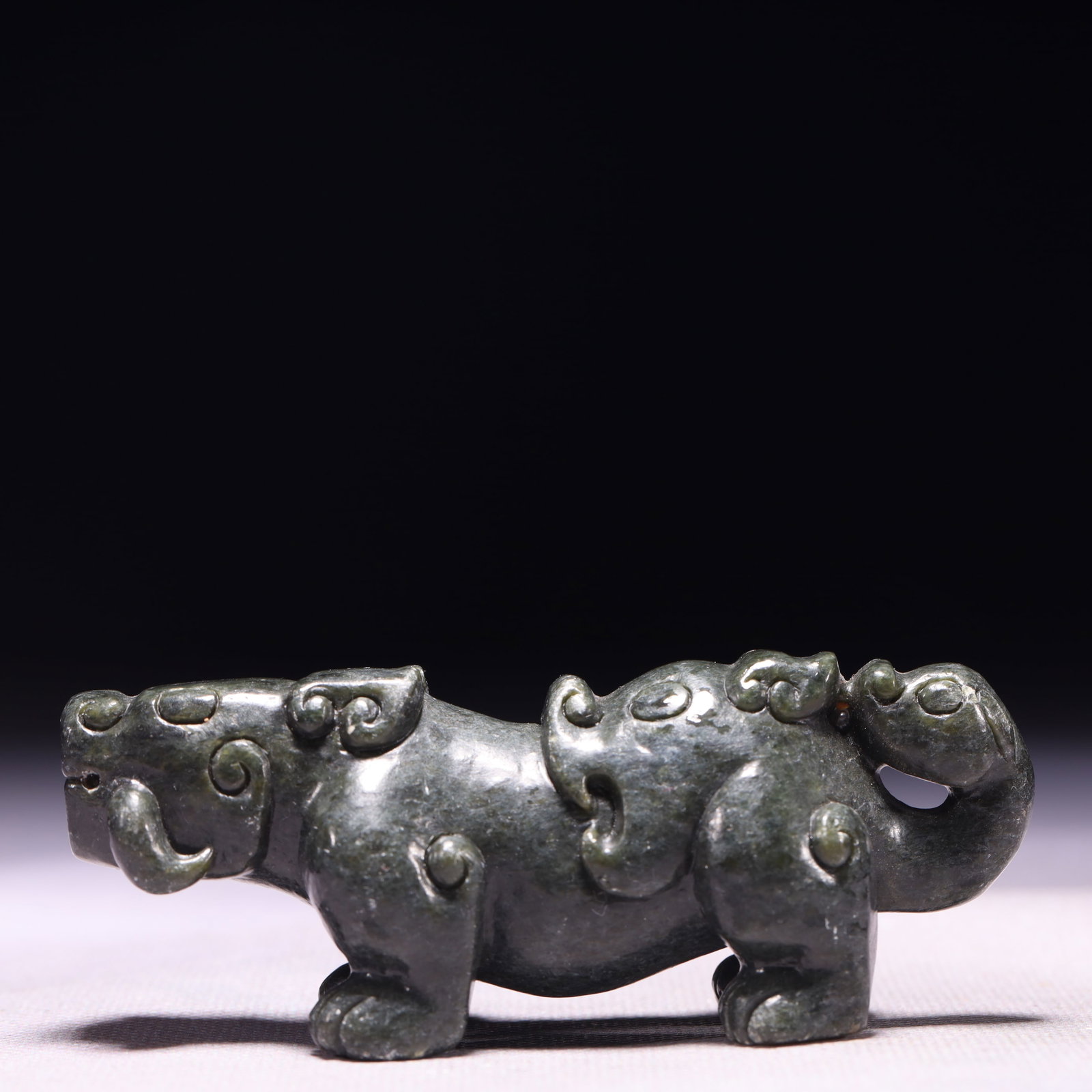 A Rare Green Jade Beast Ornament: A Rare Green Jade Beast Ornament,Qing Dynasty,China,Size:3.9inx1.2inx1.4in,Weight:167g 青玉兽摆件,中国清代