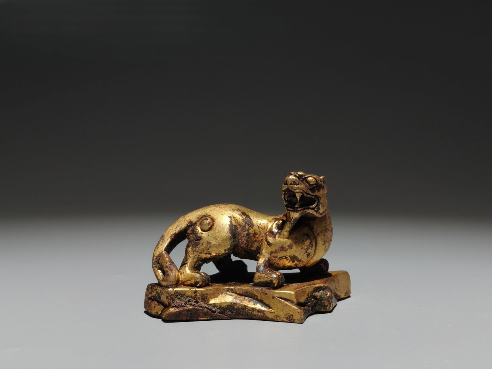 An Exquisite Gilt Bronze Beast Ornament: An Exquisite Gilt Bronze Beast Ornament,the Warring States period in China,Size:2.2inx3.5inx1.8in 铜鎏金兽摆件,中国战国时期