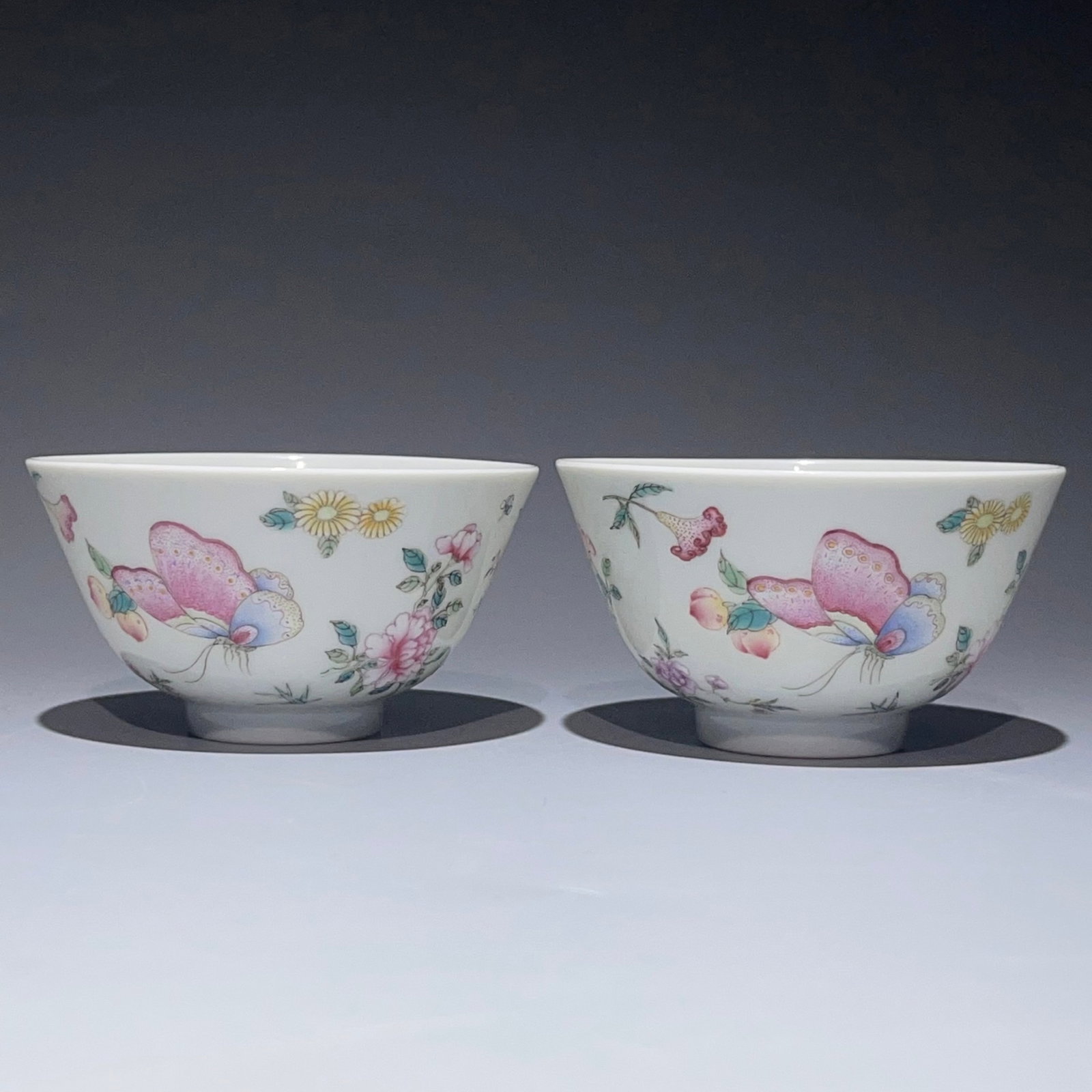 A Pair of Exquisite Famille-Rose Flower and Butterfly Pattern Cups: A Pair of Exquisite Famille-Rose Flower and Butterfly Pattern Cups,Qing Dynasty,China,Yongzheng Six-character Mark,Size:1.9inx3.3in