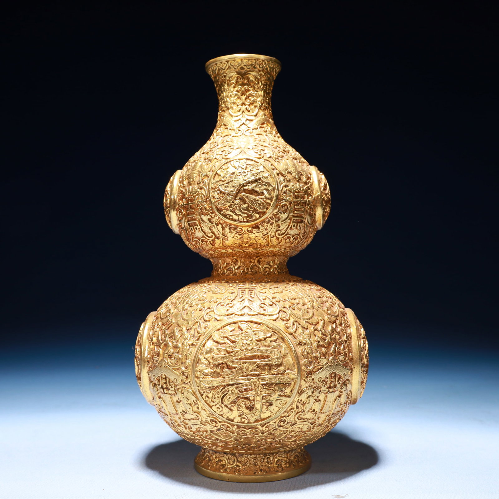 An Exquisite Gilt Bronze Bats and Peach Pattern Gourd-Shaped Vase: An Exquisite Gilt Bronze Bats and Peach Pattern Gourd-Shaped Vase,Qing Dynasty,China,Qianlong Four-character Mark,Size:5.5inx10.2inx5.5in,Weight:1300g 铜鎏金福寿纹&