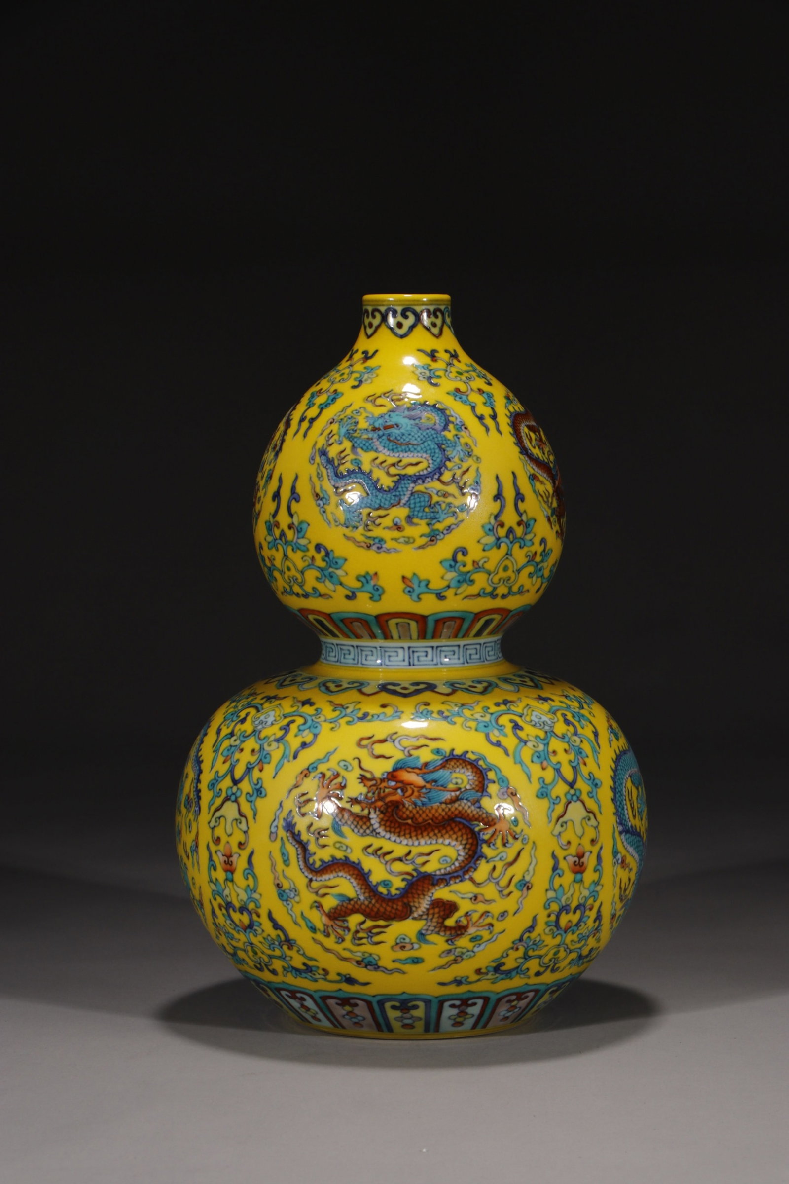 A Rare Yellow Ground Doucai Lotus and Dragon Pattern Gourd-Shaped Vase: A Rare Yellow Ground Doucai Lotus and Dragon Pattern Gourd-Shaped Vase,Qing Dynasty,China,Qianlong Six-character Mark,Size:12in 黄地斗彩缠枝莲龙纹