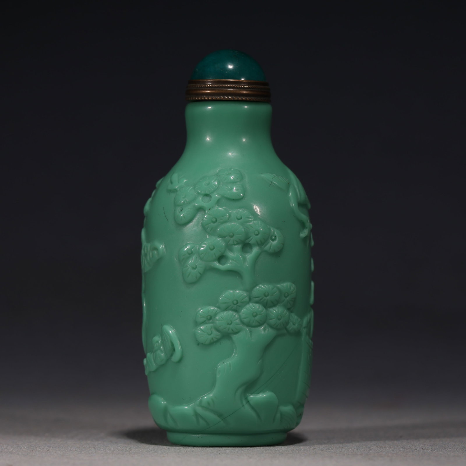 An Exquisite Turquoise Green Glass Relief Pine Crane Longevity Pattern Snuff Bottle: An Exquisite Turquoise Green Glass Relief Pine Crane Longevity Pattern Snuff Bottle,Qing Dynasty, China,Yongzheng Four-character Mark,Size:1.4in×1.4in×3.3in