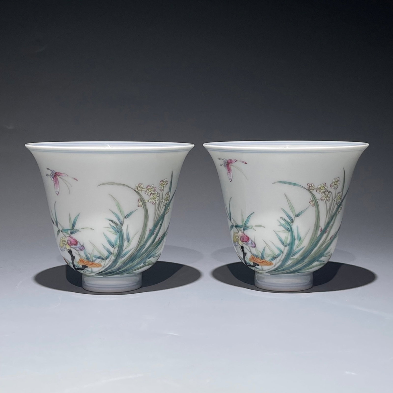A Pair of Exquisite Famille-Rose Flower and Butterfly Pattern Cups: A Pair of Exquisite Famille-Rose Flower and Butterfly Pattern Cups,Qing Dynasty,China,Yongzheng Four-character Mark,Size:3.1inx3.7in