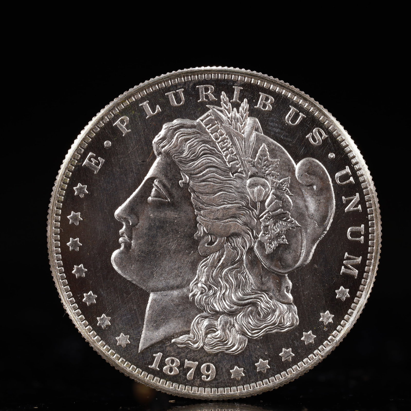 USA Morgan Dollar 1879 Coin: Obv: profile bust with date below and E PLURIBUS UNUM legend and stars around. Rev: eagle with In God we trust above within wreath with UNITED STATES OF AMERICA ONE DOLLAR legend. IN GOD WE TRUST / LI