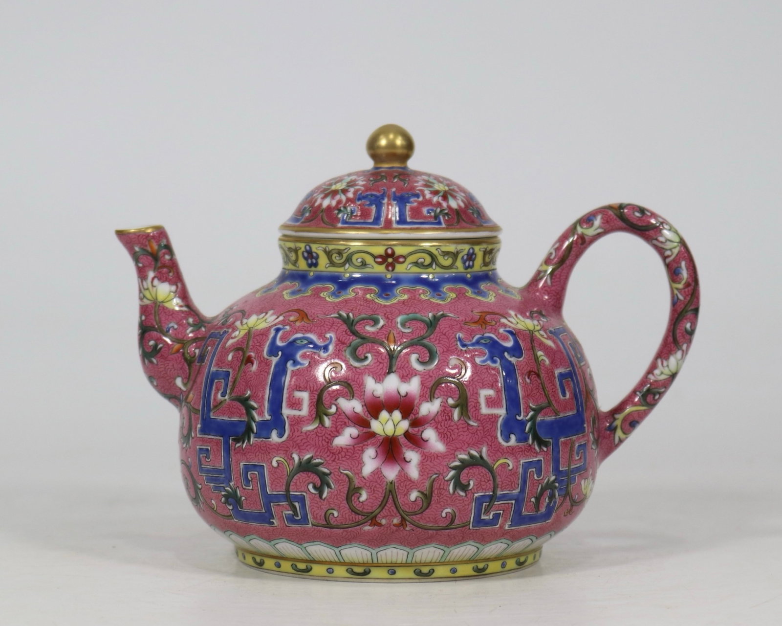 A fine carmine red ground scrolling floral dragon ewer: A fine carmine red ground scrolling floral dragon ewer, Qing Dynasty, China, with six-character Qianlong reign mark, Size:5.1inx6.7in