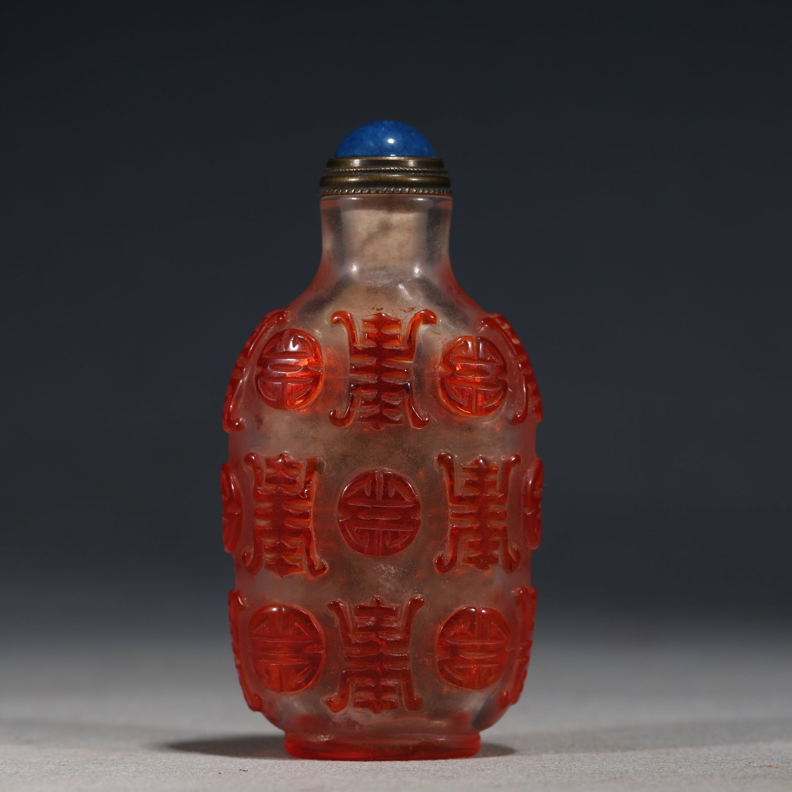 An Exquisite Overlaid Red Glass Snuff Bottle With Round Longevity Character Pattern: An Exquisite Overlaid Red Glass Snuff Bottle With Round Longevity Character Pattern,China,Qing Dynasty,Four-Character Qianlong