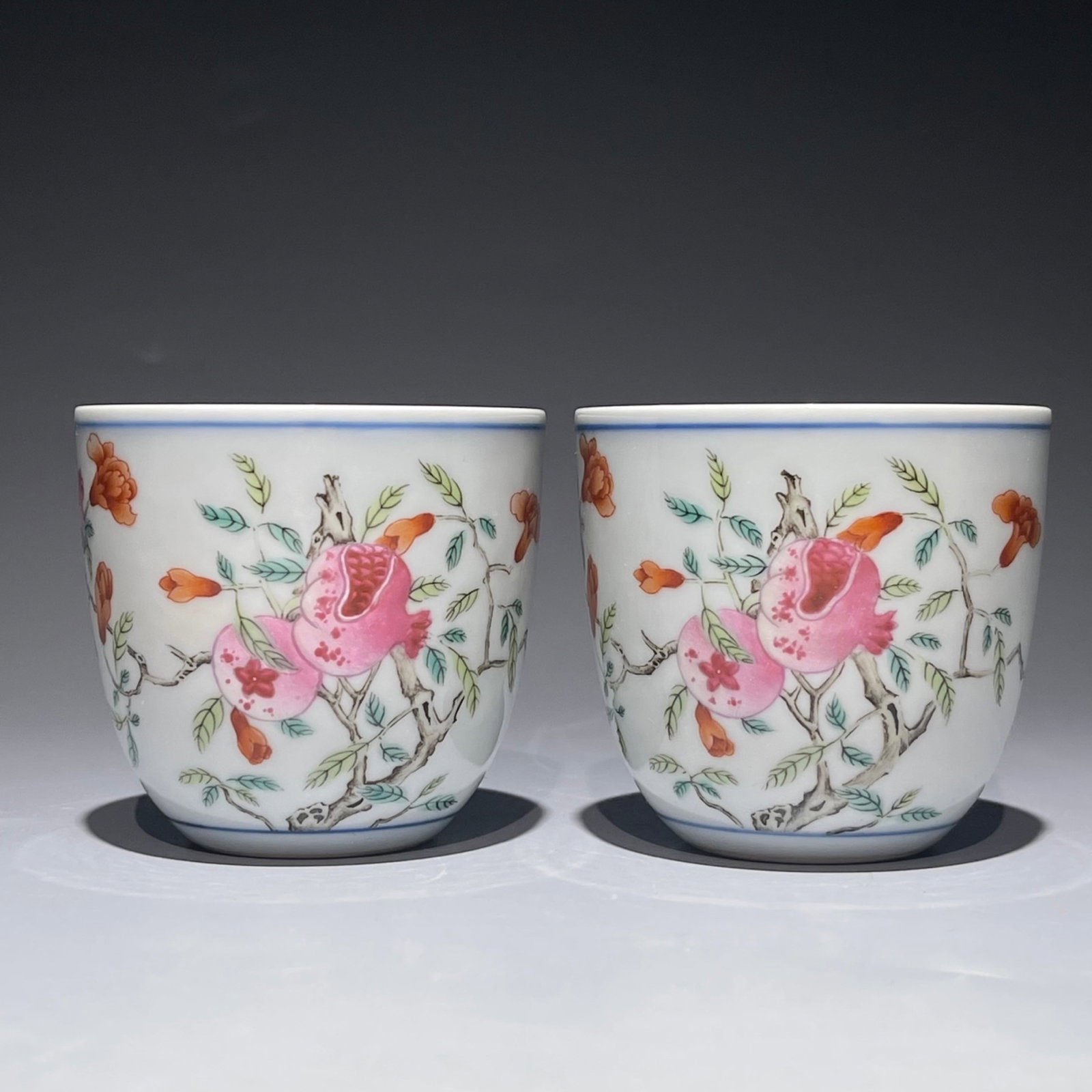 A Pair of Exquisite Famille-Rose Pomegranate Pattern Cups: A Pair of Exquisite Famille-Rose Pomegranate Pattern Cups,Qing Dynasty,China,Qianlong Six-character Mark,Size:2.4inx2.6in 一对粉彩石榴纹杯子,È