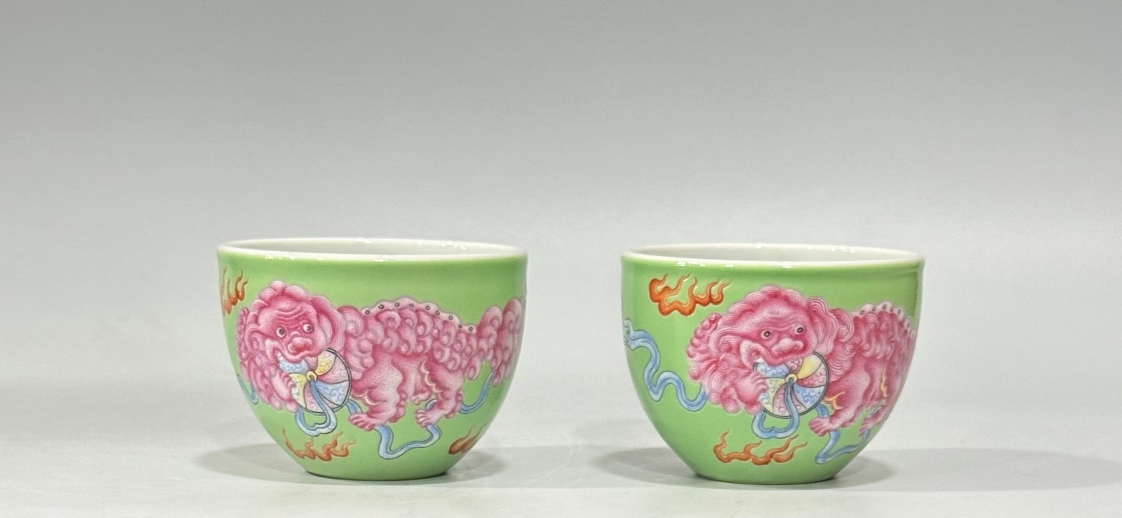 A Pair of Exquisite Green Ground Enamel Lion Pattern Cups: A Pair of Exquisite Green Ground Enamel Lion Pattern Cups,Qing Dynasty,China,Yongzheng Four-character Mark,Size:2inx2.8in 一对绿地珐琅彩狮子ಬ