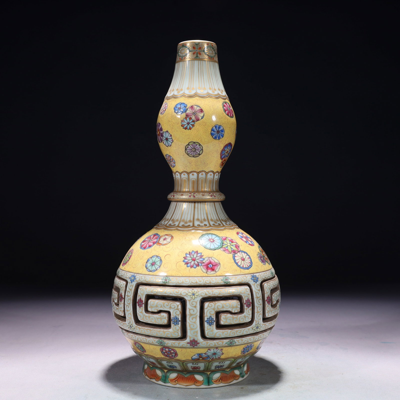 An Exquisite Yellow Ground Famille-Rose Painted Gold Flower Pattern Gourd-Shaped Vase: An Exquisite Yellow Ground Famille-Rose Painted Gold Flower Pattern Gourd-Shaped Vase,Qing Dynasty,China,Qianlong Six-character Mark,Size:5.5inx12.2in,Weight:1650g 黄地粉彩