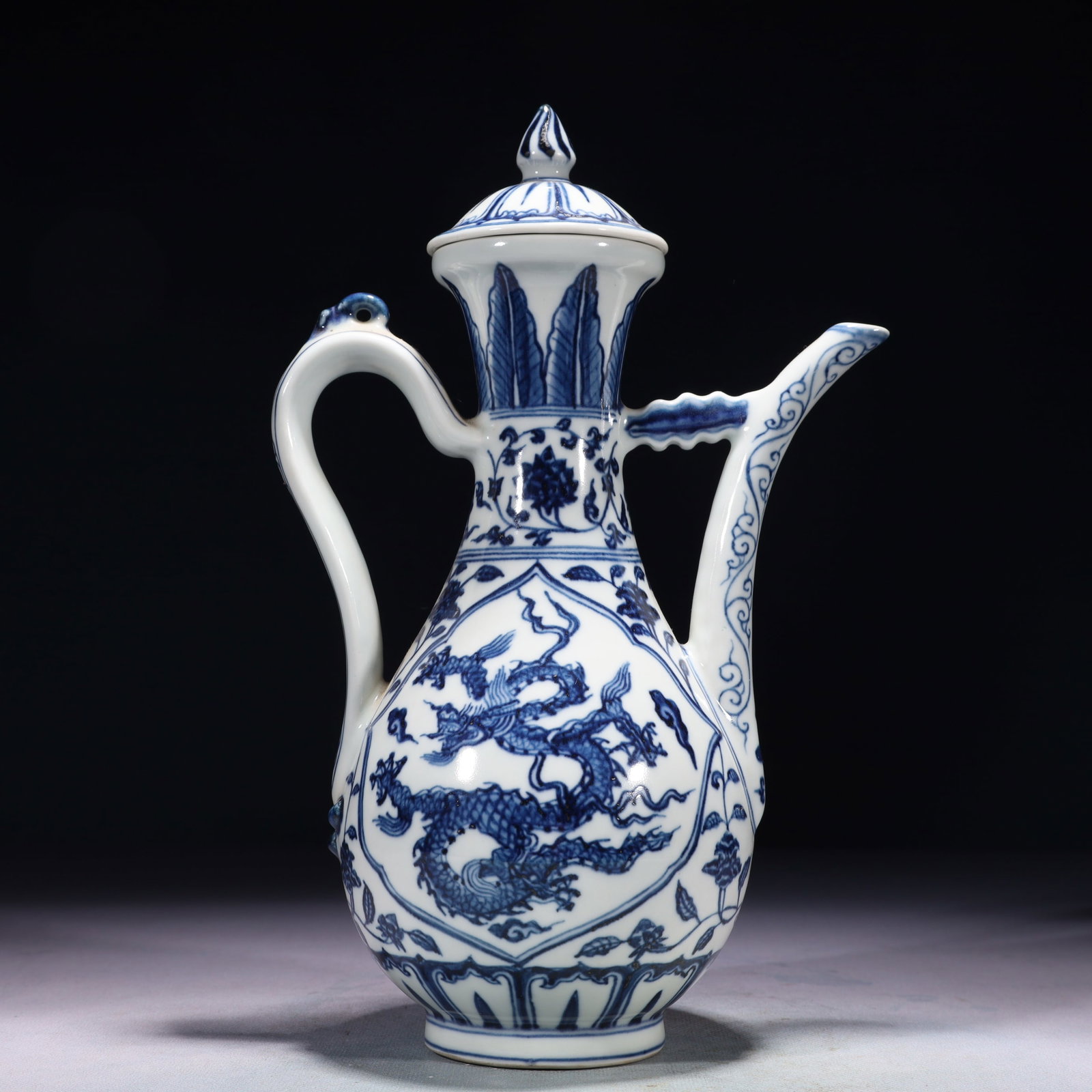 An Exquisite Blue and White Auspicious Cloud and Dragon Pattern Ewer: An Exquisite Blue and White Auspicious Cloud and Dragon Pattern Ewer,Ming Dynasty,China,Xuande Six-character Mark,Size:7.1inx4.7inx11.4in,Weight:1150g